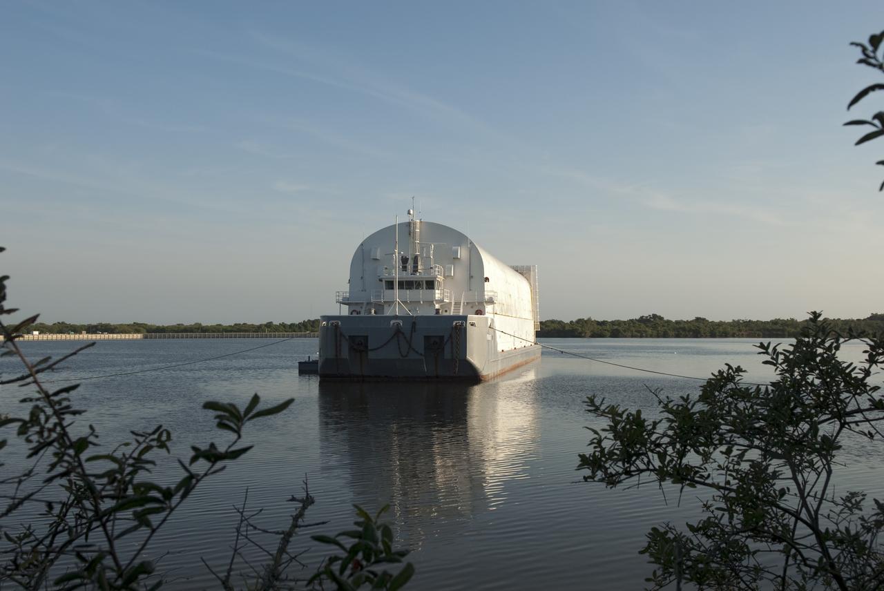 CAPE CANAVERAL, Fla. -- Tugboats in the Turn Basin in the Launch Complex 39 area at NASA's Kennedy Space Center in Florida have towed the Pegasus Barge from the dock to a more secure mooring area. The barge is 266 ft long and 50 ft wide and has been used by the Space Shuttle Program to transport external fuel tanks over 900 miles of inland and open ocean waterways from the Michoud Assembly Facility in Louisiana to Kennedy. Photo credit: NASA/Jim Grossmann