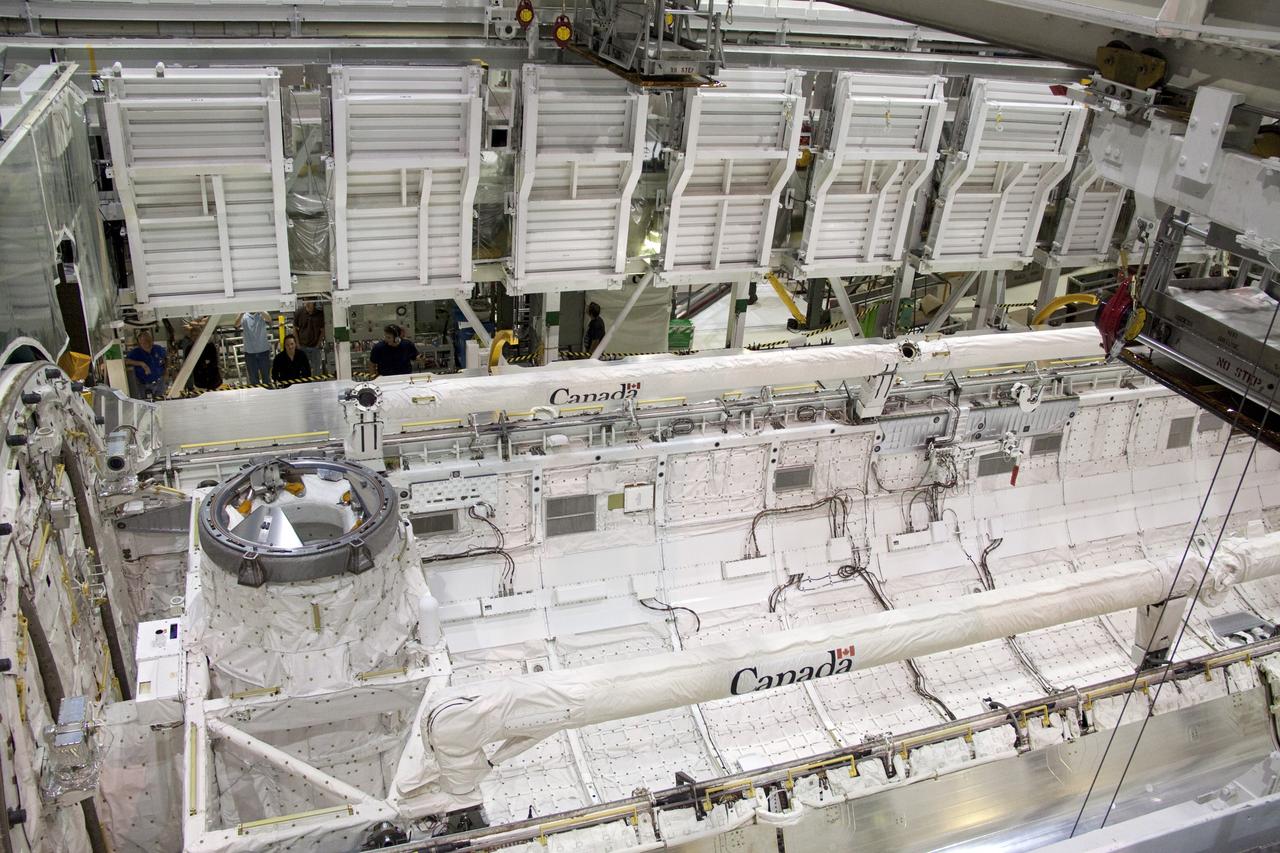 CAPE CANAVERAL, Fla. - In Orbiter Processing Facility-1 at NASA's Kennedy Space Center in Florida, the Ku-band antenna is being stowed in space shuttle Atlantis' payload bay. The antenna, which resembles a mini-satellite dish, transmits audio, video and data between Earth and the shuttle. Next, the clamshell doors of the payload bay will close completely in preparation for its move to the Vehicle Assembly Building. Atlantis is being prepared for the STS-135 mission, which will deliver the Raffaello multipurpose logistics module packed with supplies, logistics and spare parts to the International Space Station. STS-135 is targeted to launch June 28, and will be the last spaceflight for the Space Shuttle Program. Photo credit: NASA/Jack Pfaller