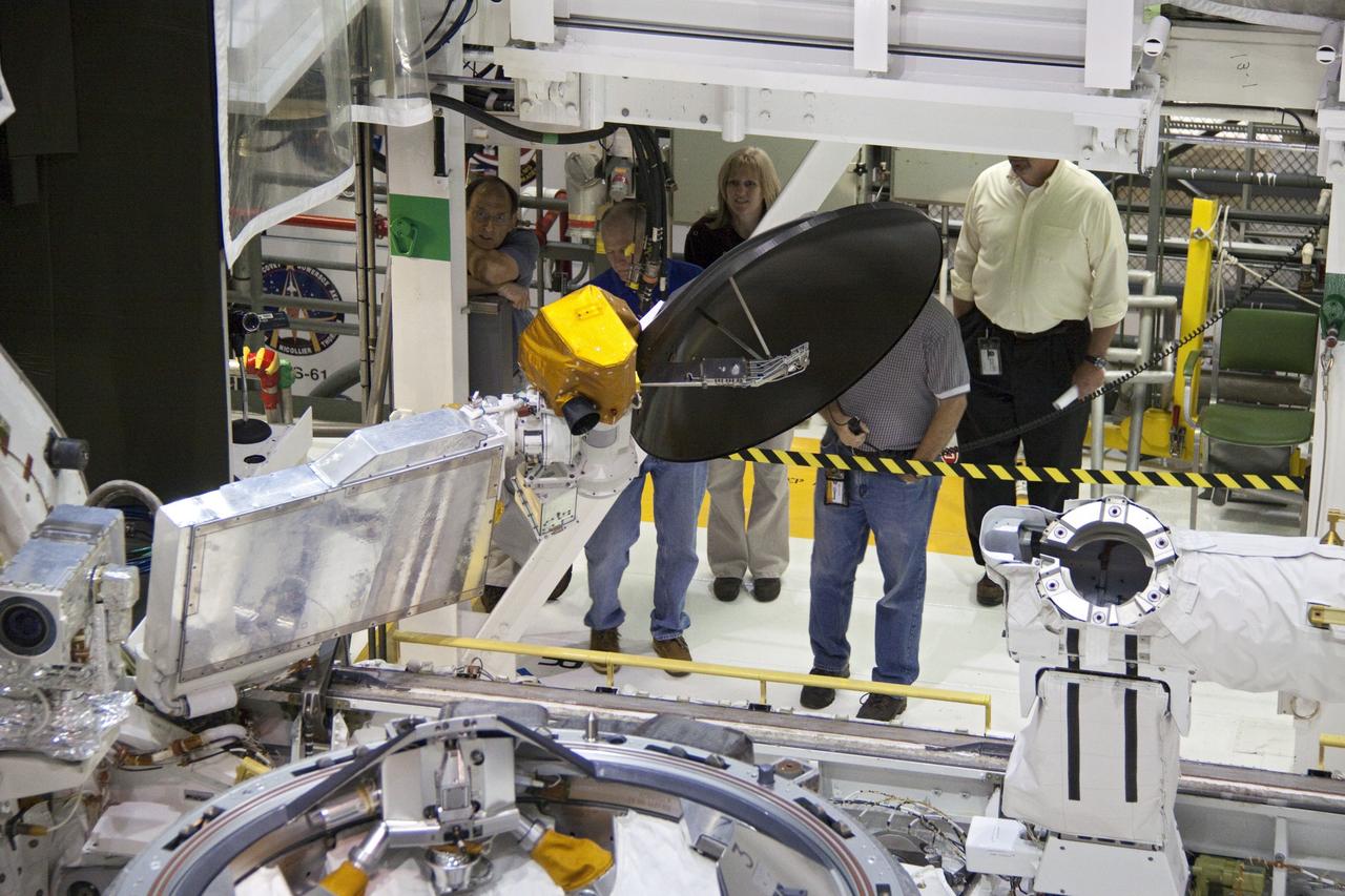 CAPE CANAVERAL, Fla. - In Orbiter Processing Facility-1 at NASA's Kennedy Space Center in Florida, the Ku-band antenna is being stowed in space shuttle Atlantis' payload bay. The antenna, which resembles a mini-satellite dish, transmits audio, video and data between Earth and the shuttle. Next, the clamshell doors of the payload bay will close completely in preparation for its move to the Vehicle Assembly Building. Atlantis is being prepared for the STS-135 mission, which will deliver the Raffaello multipurpose logistics module packed with supplies, logistics and spare parts to the International Space Station. STS-135 is targeted to launch June 28, and will be the last spaceflight for the Space Shuttle Program. Photo credit: NASA/Jack Pfaller