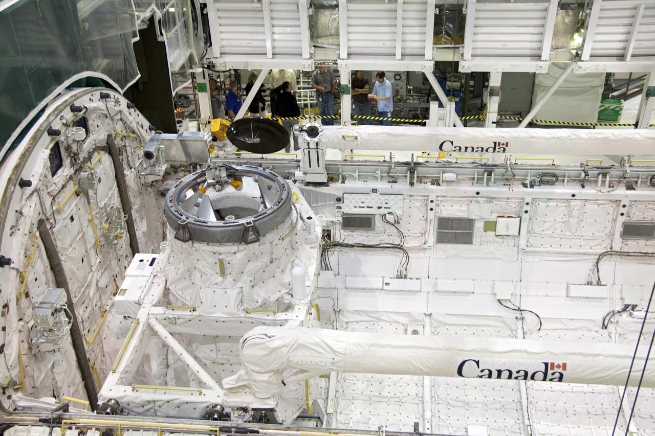 CAPE CANAVERAL, Fla. - In Orbiter Processing Facility-1 at NASA's Kennedy Space Center in Florida, the Ku-band antenna is stowed in space shuttle Atlantis' payload bay. The antenna, which resembles a mini-satellite dish, transmits audio, video and data between Earth and the shuttle. Next, the clamshell doors of the payload bay will close completely in preparation for its move to the Vehicle Assembly Building. Atlantis is being prepared for the STS-135 mission, which will deliver the Raffaello multipurpose logistics module packed with supplies, logistics and spare parts to the International Space Station. STS-135 is targeted to launch June 28, and will be the last spaceflight for the Space Shuttle Program. Photo credit: NASA/Jack Pfaller