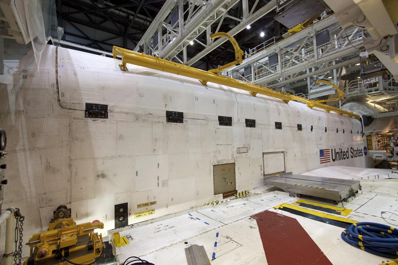 CAPE CANAVERAL, Fla. - In Orbiter Processing Facility-1 at NASA's Kennedy Space Center in Florida, the clamshell doors of space shuttle Atlantis' payload bay have been closed in preparation for the its move to the Vehicle Assembly Building next month. Atlantis is being prepared for the STS-135 mission, which will deliver the Raffaello multipurpose logistics module packed with supplies, logistics and spare parts to the International Space Station. STS-135 is targeted to launch June 28, and will be the last spaceflight for the Space Shuttle Program. Photo credit: NASA/Jack Pfaller