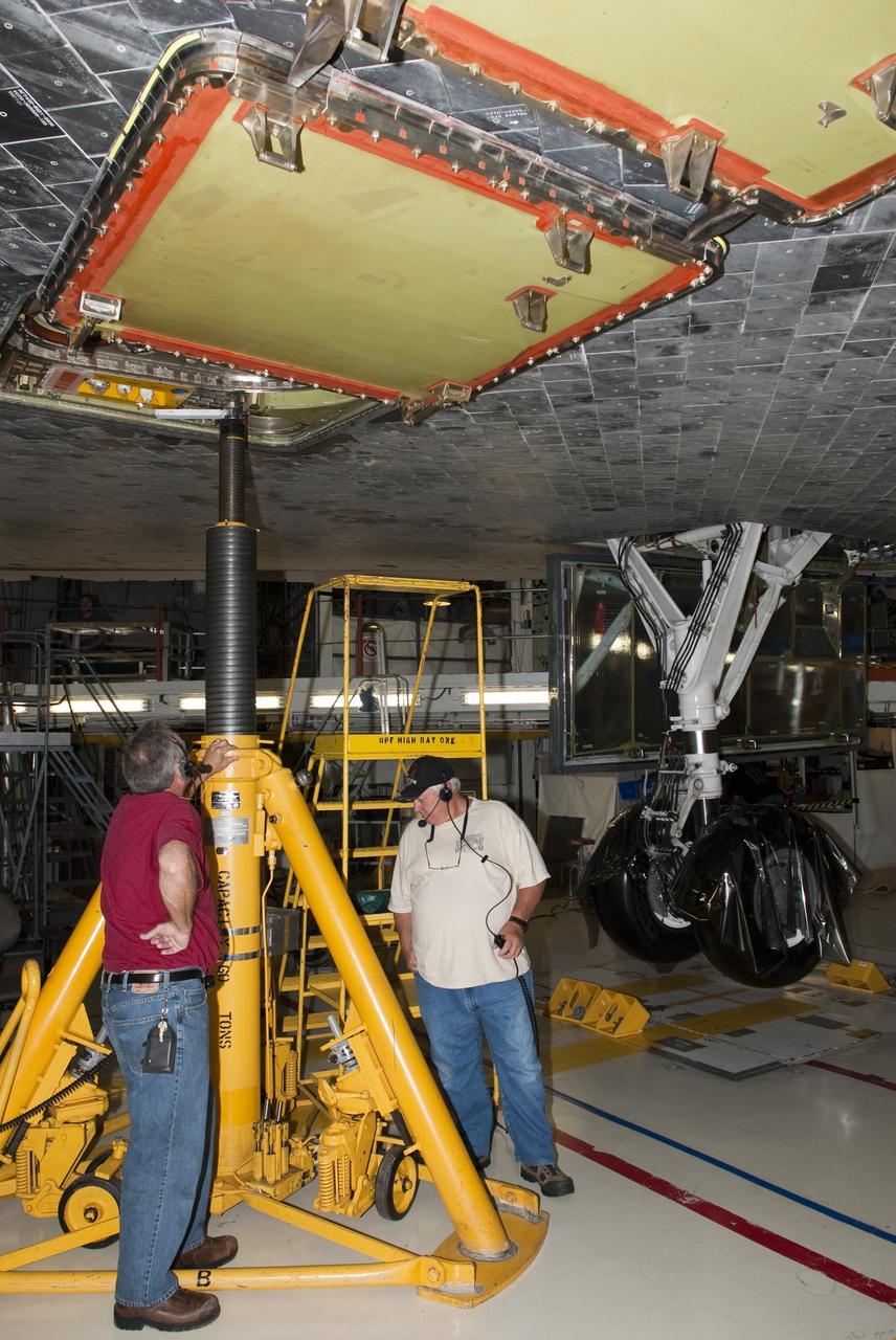 CAPE CANAVERAL, Fla. - In Orbiter Processing Facility-1 at NASA's Kennedy Space Center in Florida, workers test the hydraulic system that will lift the shuttle Atlantis off the floor to enable the orbiter transport system, or OTS, to be rolled underneath for its move, or "rollover," to the Vehicle Assembly Building. Once there Atlantis will be joined with the external fuel tank and solid rocket boosters on the mobile launcher platform. Atlantis is being prepared for the STS-135 mission, which will deliver the Raffaello multipurpose logistics module packed with supplies, logistics and spare parts to the International Space Station. STS-135 is targeted to launch June 28, and will be the last spaceflight for the Space Shuttle Program. Photo credit: NASA/Jim Grossmann