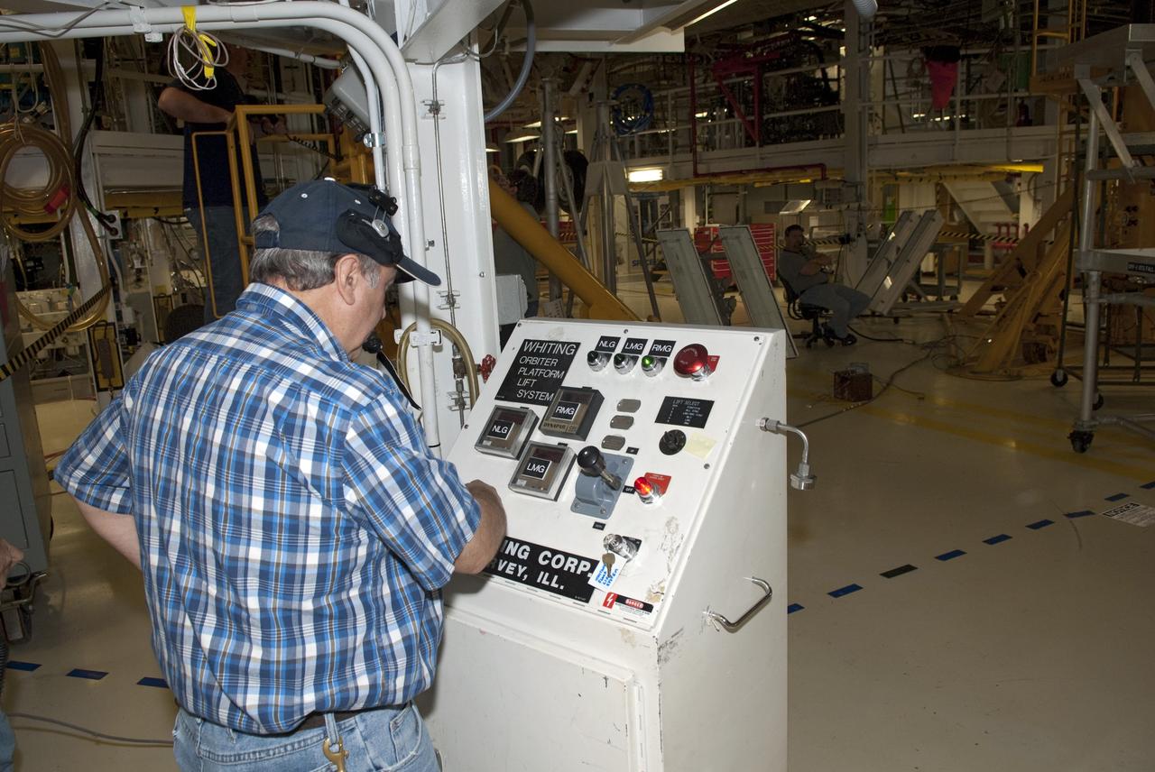 CAPE CANAVERAL, Fla. - In Orbiter Processing Facility-1 at NASA's Kennedy Space Center in Florida, a worker tests the hydraulic system that will lift the shuttle Atlantis off the floor to enable the orbiter transport system, or OTS, to be rolled underneath for its move, or "rollover," to the Vehicle Assembly Building. Once there Atlantis will be joined with the external fuel tank and solid rocket boosters on the mobile launcher platform. Atlantis is being prepared for the STS-135 mission, which will deliver the Raffaello multipurpose logistics module packed with supplies, logistics and spare parts to the International Space Station. STS-135 is targeted to launch June 28, and will be the last spaceflight for the Space Shuttle Program. Photo credit: NASA/Jim Grossmann