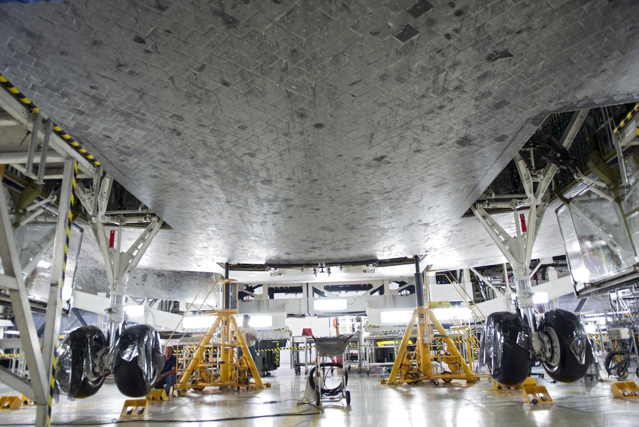 CAPE CANAVERAL, Fla. - In Orbiter Processing Facility-1 at NASA's Kennedy Space Center in Florida, a hydraulic system has lifted shuttle Atlantis off the floor to enable the orbiter transport system, or OTS, to be rolled underneath for its move, or "rollover," to the Vehicle Assembly Building. Once there Atlantis will be joined with the external fuel tank and solid rocket boosters on the mobile launcher platform. Atlantis is being prepared for the STS-135 mission, which will deliver the Raffaello multipurpose logistics module packed with supplies, logistics and spare parts to the International Space Station. STS-135 is targeted to launch June 28, and will be the last spaceflight for the Space Shuttle Program. Photo credit: NASA/Jim Grossmann