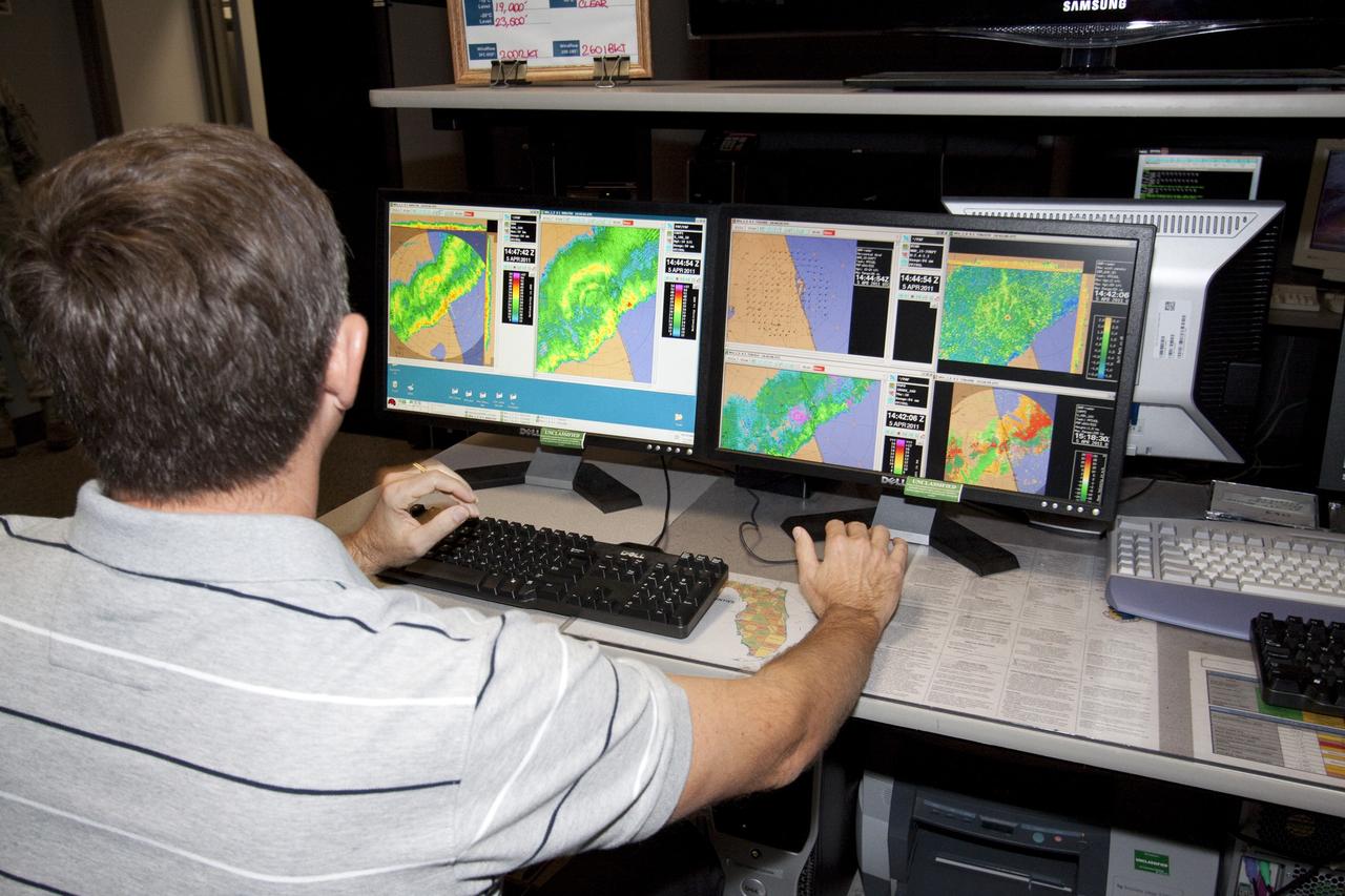 CAPE CANAVERAL, Fla. - At the Cape Canaveral Air Force Station forecast facility in Florida, a member of the weather team demonstrates the effectiveness of the new weather radar display recently installed. The facility is operated by the U.S. Air Force 45th Weather Squadron and will generate a launch weather forecast for the scheduled July 8 lift off of space shuttle Atlantis on the STS-135 mission. Photo credit: NASA/Jack Pfaller