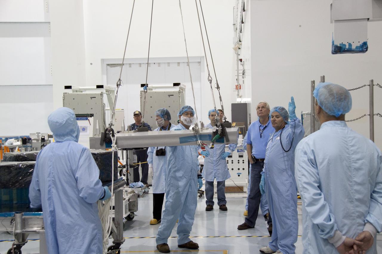 CAPE CANAVERAL, Fla. - In the Space Station Processing Facility at NASA's Kennedy Space Center in Florida, technicians monitor the progress of an overhead crane as it lifts the pump module assembly plate for transfer to the Lightweight Multi-Purpose Experiment Support Structure Carrier, or LMC. The module assembly will be used to secure the return of a failed ammonia pump module in shuttle Atlantis' payload bay. Atlantis and its payload are being prepared for the STS-135 mission, which will deliver the Raffaello multipurpose logistics module packed with supplies, logistics and spare parts to the International Space Station. STS-135 is targeted to launch June 28, and will be the last spaceflight for the Space Shuttle Program. Photo credit: NASA/Jack Pfaller