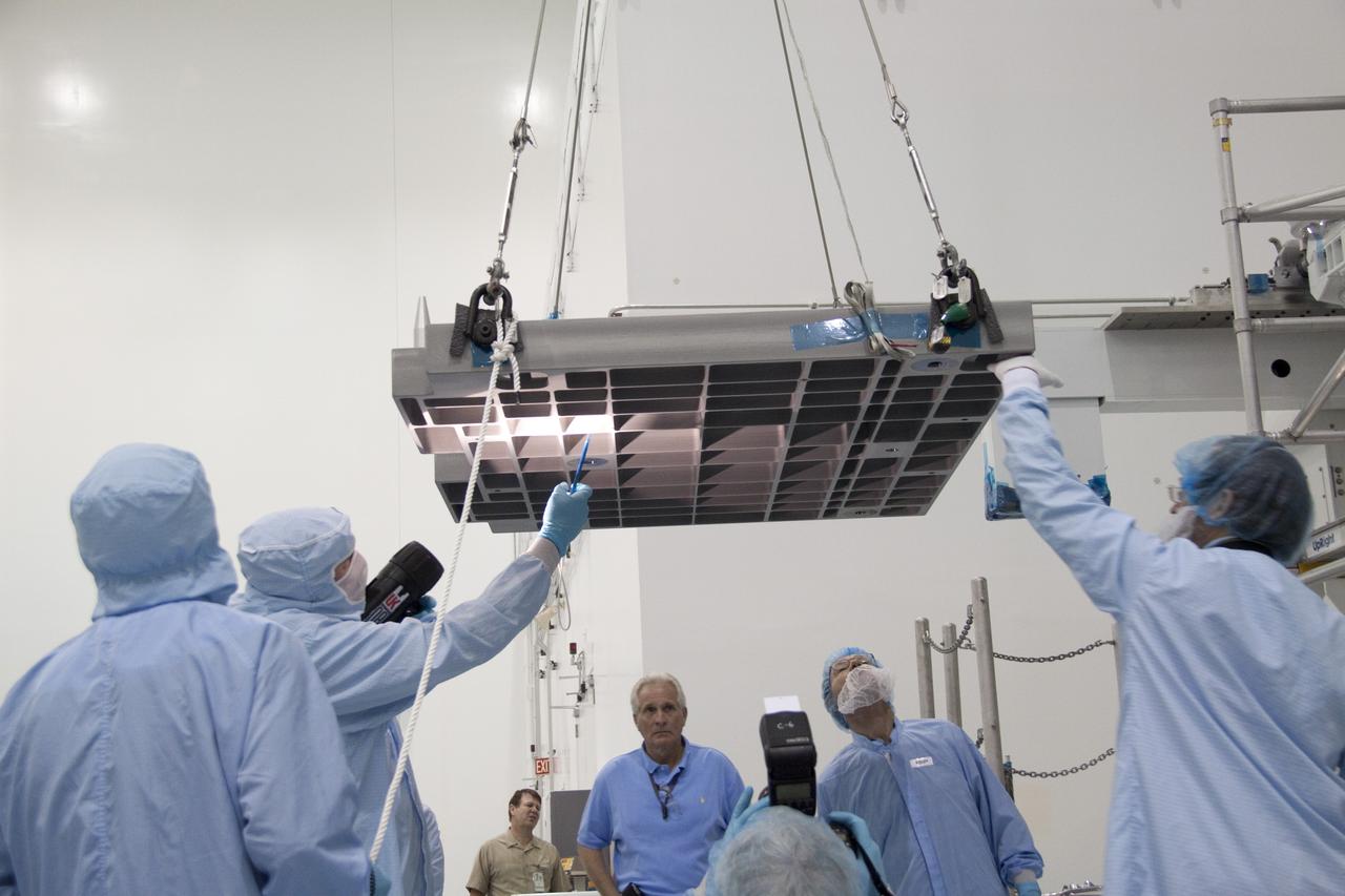 CAPE CANAVERAL, Fla. - In the Space Station Processing Facility at NASA's Kennedy Space Center in Florida, technicians guide an overhead crane as it lifts the pump module assembly plate for transfer to the Lightweight Multi-Purpose Experiment Support Structure Carrier, or LMC. The module assembly will be used to secure the return of a failed ammonia pump module in shuttle Atlantis' payload bay. Atlantis and its payload are being prepared for the STS-135 mission, which will deliver the Raffaello multipurpose logistics module packed with supplies, logistics and spare parts to the International Space Station. STS-135 is targeted to launch June 28, and will be the last spaceflight for the Space Shuttle Program. Photo credit: NASA/Jack Pfaller
