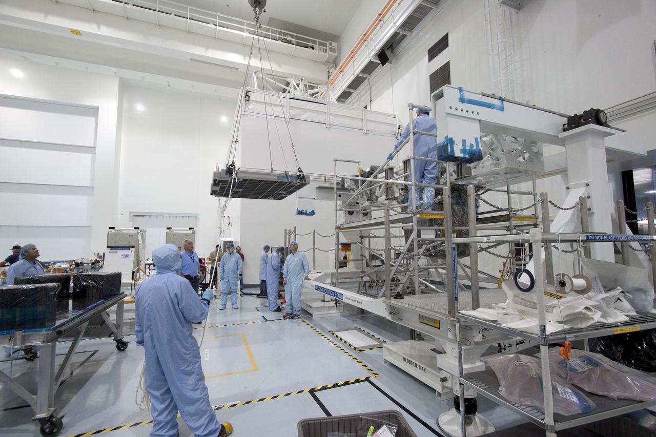 CAPE CANAVERAL, Fla. - In the Space Station Processing Facility at NASA's Kennedy Space Center in Florida, technicians guide an overhead crane as it lifts the pump module assembly plate for transfer to the Lightweight Multi-Purpose Experiment Support Structure Carrier, or LMC. The module assembly will be used to secure the return of a failed ammonia pump module in shuttle Atlantis' payload bay. Atlantis and its payload are being prepared for the STS-135 mission, which will deliver the Raffaello multipurpose logistics module packed with supplies, logistics and spare parts to the International Space Station. STS-135 is targeted to launch June 28, and will be the last spaceflight for the Space Shuttle Program. Photo credit: NASA/Jack Pfaller