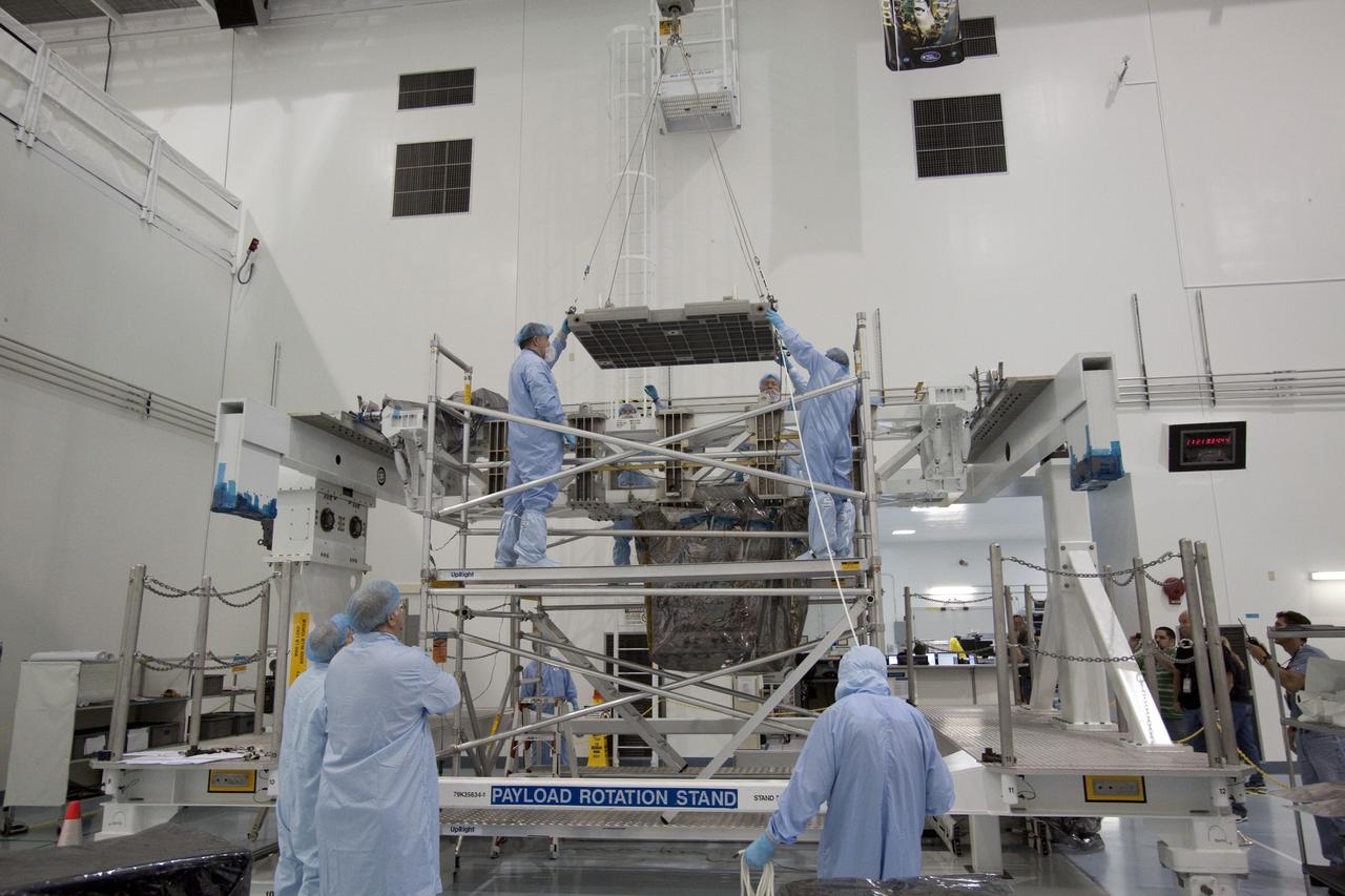 CAPE CANAVERAL, Fla. - In the Space Station Processing Facility at NASA's Kennedy Space Center in Florida, technicians guide an overhead crane as it lowers the pump module assembly plate toward the Lightweight Multi-Purpose Experiment Support Structure Carrier, or LMC. The module assembly will be used to secure the return of a failed ammonia pump module in shuttle Atlantis' payload bay. Atlantis and its payload are being prepared for the STS-135 mission, which will deliver the Raffaello multipurpose logistics module packed with supplies, logistics and spare parts to the International Space Station. STS-135 is targeted to launch June 28, and will be the last spaceflight for the Space Shuttle Program. Photo credit: NASA/Jack Pfaller