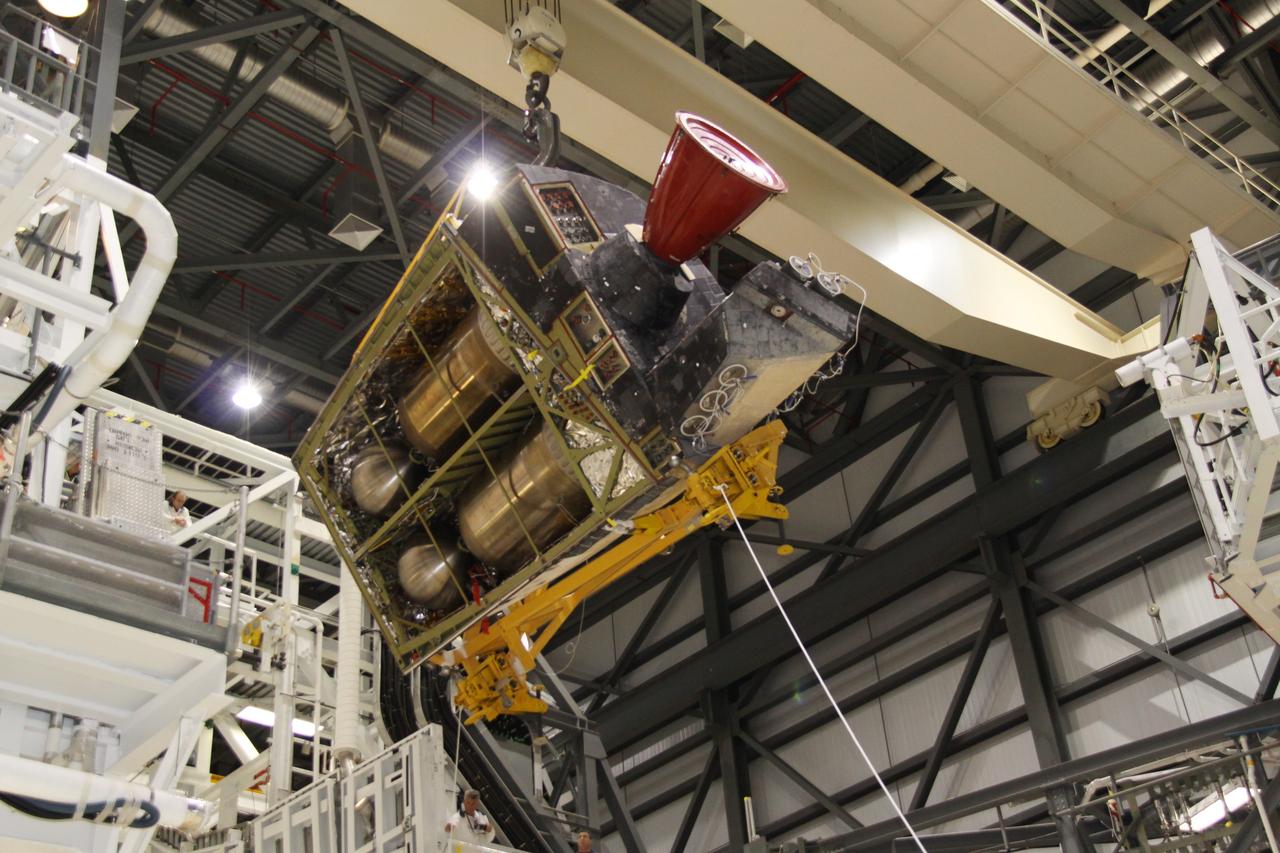 CAPE CANAVERAL, Fla. -- In Orbiter Processing Facility-2 at NASA's Kennedy Space Center in Florida, an overhead crane removes shuttle Discovery's right-hand orbital maneuvering system, or OMS, pod. It then will be transported to the Hypergol Maintenance Facility. The removal is part of Discovery's transition and retirement processing. Work performed on Discovery is expected to help rocket designers build next-generation spacecraft and prepare the shuttle for future public display. Photo credit: NASA/Jack Pfaller