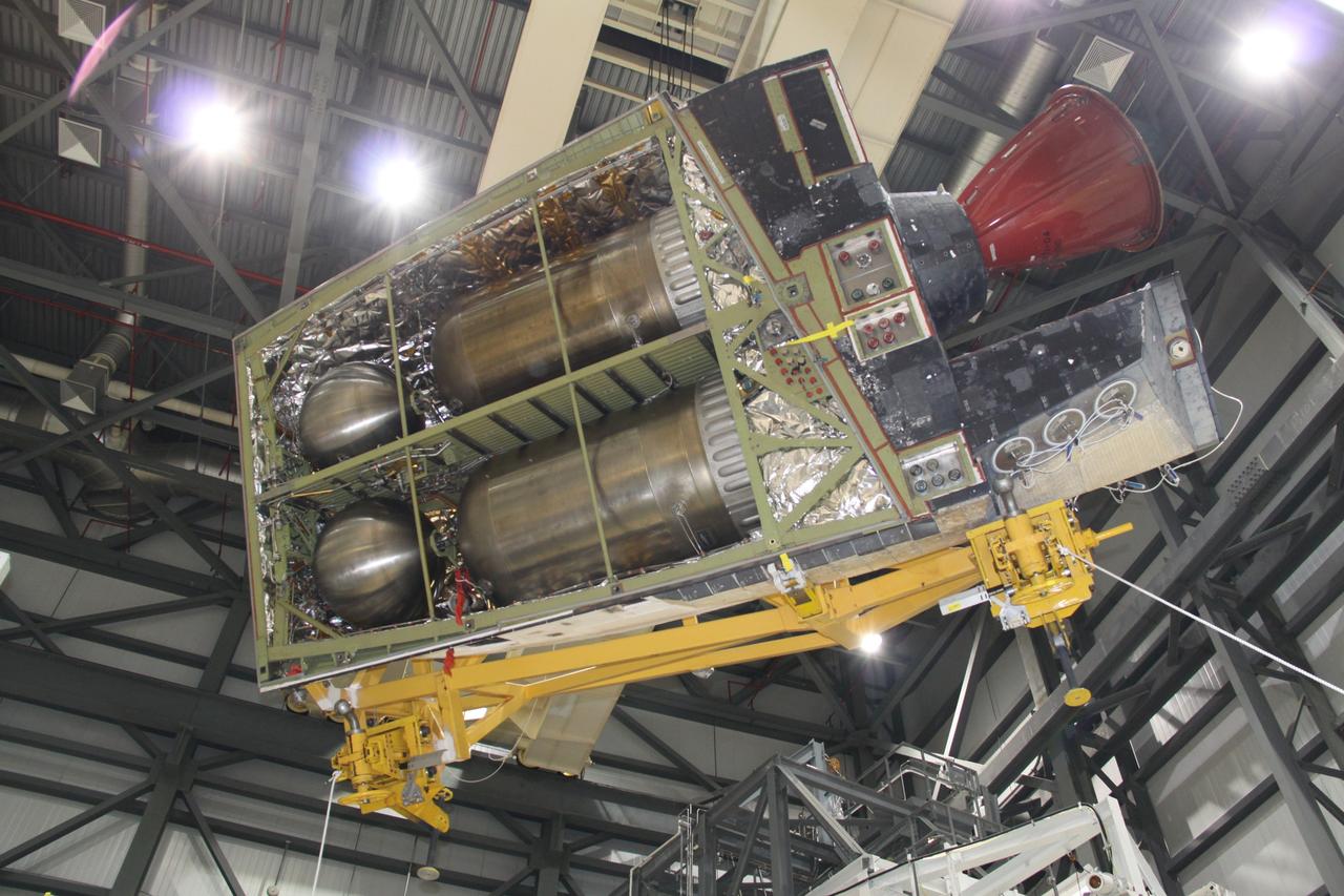 CAPE CANAVERAL, Fla. -- In Orbiter Processing Facility-2 at NASA's Kennedy Space Center in Florida, an overhead crane removes shuttle Discovery's right-hand orbital maneuvering system, or OMS, pod. It then will be transported to the Hypergol Maintenance Facility. The removal is part of Discovery's transition and retirement processing. Work performed on Discovery is expected to help rocket designers build next-generation spacecraft and prepare the shuttle for future public display. Photo credit: NASA/Jack Pfaller
