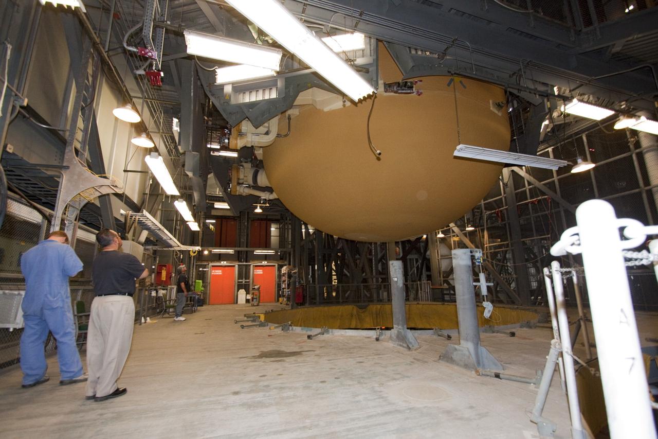 CAPE CANAVERAL, Fla. - In the Vehicle Assembly Building (VAB) at NASA's Kennedy Space Center in Florida, workers monitor the progress of external fuel tank, ET-138, for space shuttle Atlantis' STS-135 mission, as it is lifted from its test cell for transfer to high bay-1 for joining with the twin solid rocket boosters on the mobile launcher platform. Shuttle Atlantis' move, or "rollover," from Orbiter Processing Facility-1 to the VAB is targeted for May 10. Once there it will be mated with the external tank and boosters. Atlantis and its crew of four will deliver the Raffaello multipurpose logistics module packed with supplies and spare parts to the International Space Station. STS-135 is targeted to launch June 28, and will be the last spaceflight for the Space Shuttle Program. Photo credit: NASA/Jack Pfaller