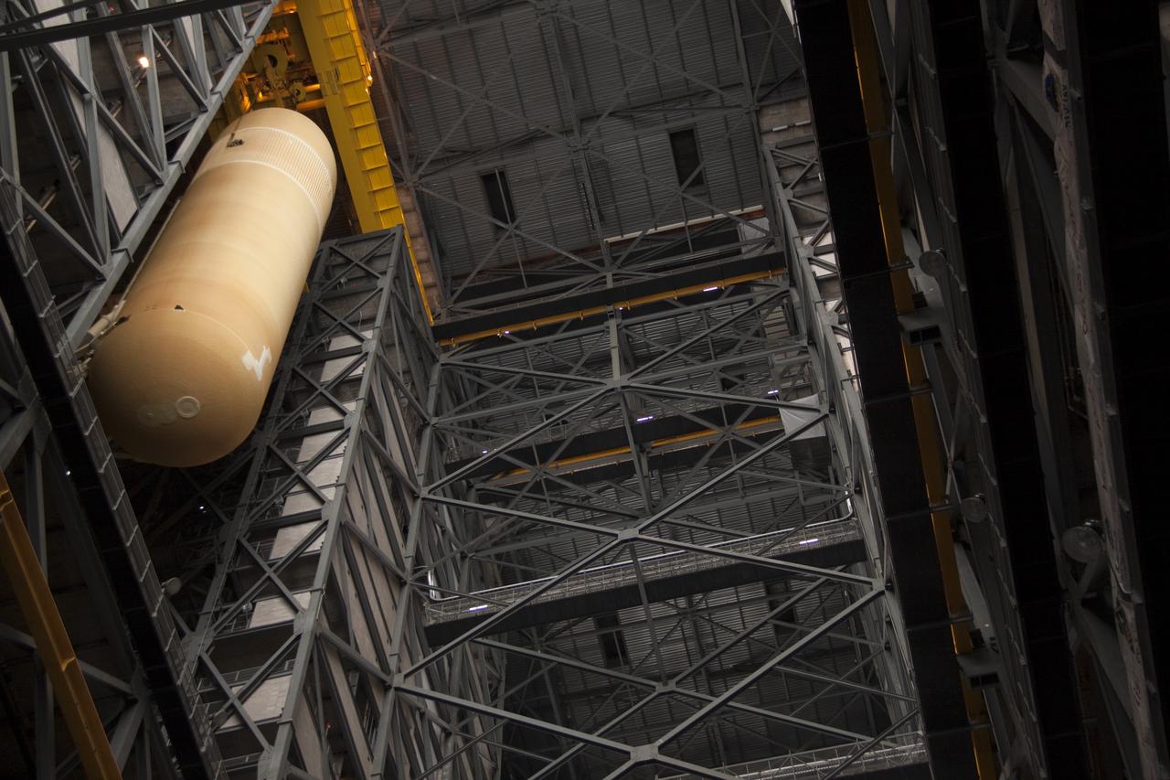 CAPE CANAVERAL, Fla. - In the Vehicle Assembly Building (VAB) at NASA's Kennedy Space Center in Florida, external fuel tank, ET-138, for space shuttle Atlantis' STS-135 mission, is lowered into high bay-1 for joining with the twin solid rocket boosters on the mobile launcher platform. Shuttle Atlantis' move, or "rollover," from Orbiter Processing Facility-1 to the VAB is targeted for May 10. Once there it will be mated with the external tank and boosters. Atlantis and its crew of four will deliver the Raffaello multipurpose logistics module packed with supplies and spare parts to the International Space Station. STS-135 is targeted to launch June 28, and will be the last spaceflight for the Space Shuttle Program. Photo credit: NASA/Jack Pfaller