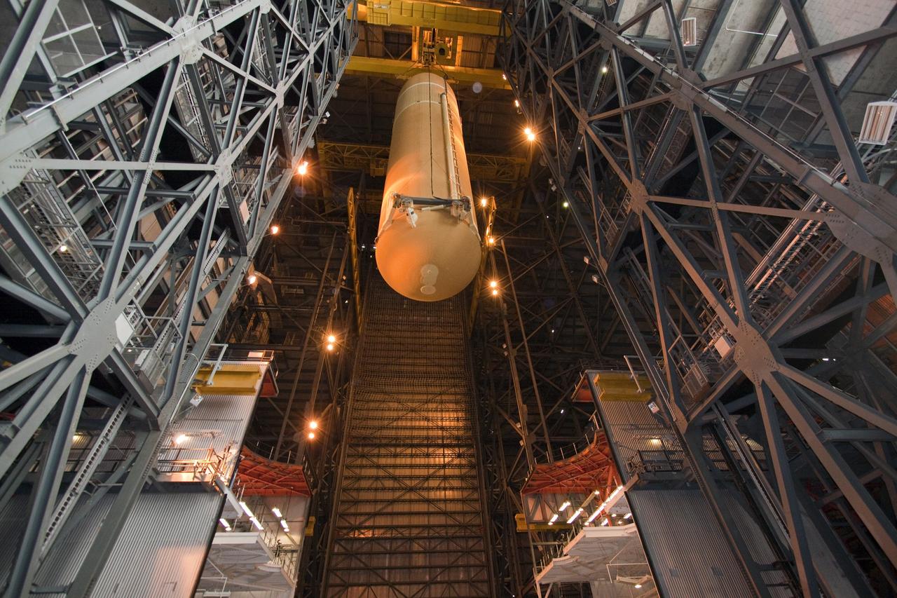 CAPE CANAVERAL, Fla. - In the Vehicle Assembly Building (VAB) at NASA's Kennedy Space Center in Florida, external fuel tank, ET-138, for space shuttle Atlantis' STS-135 mission, is lowered into high bay-1 for joining with the twin solid rocket boosters on the mobile launcher platform. Shuttle Atlantis' move, or "rollover," from Orbiter Processing Facility-1 to the VAB is targeted for May 10. Once there it will be mated with the external tank and boosters. Atlantis and its crew of four will deliver the Raffaello multipurpose logistics module packed with supplies and spare parts to the International Space Station. STS-135 is targeted to launch June 28, and will be the last spaceflight for the Space Shuttle Program. Photo credit: NASA/Jack Pfaller
