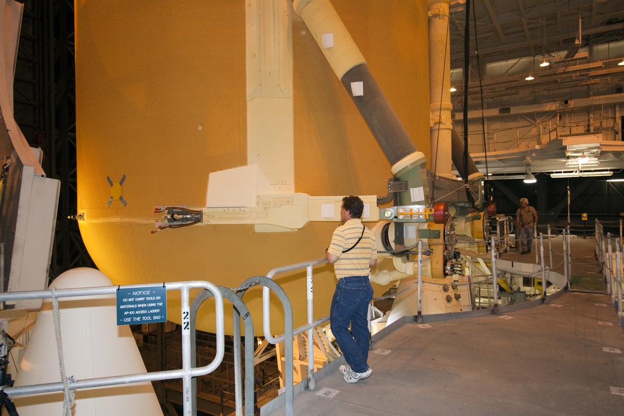 CAPE CANAVERAL, Fla. - In the Vehicle Assembly Building (VAB) at NASA's Kennedy Space Center in Florida, workers monitor the progress of external fuel tank, ET-138, for space shuttle Atlantis' STS-135 mission, as it is lowered into high bay-1 between the twin solid rocket boosters on the mobile launcher platform. Shuttle Atlantis' move, or "rollover," from Orbiter Processing Facility-1 to the VAB is targeted for May 10. Once there it will be mated with the external tank and boosters. Atlantis and its crew of four will deliver the Raffaello multipurpose logistics module packed with supplies and spare parts to the International Space Station. STS-135 is targeted to launch June 28, and will be the last spaceflight for the Space Shuttle Program. Photo credit: NASA/Jack Pfaller