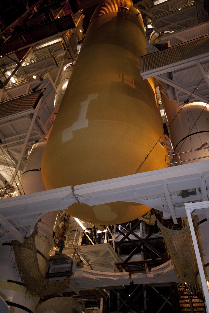 CAPE CANAVERAL, Fla. - In the Vehicle Assembly Building (VAB) at NASA's Kennedy Space Center in Florida, external fuel tank, ET-138, for space shuttle Atlantis' STS-135 mission, is being lowered between the twin solid rocket boosters on the mobile launcher platform in high bay-1. Shuttle Atlantis' move, or "rollover," from Orbiter Processing Facility-1 to the VAB is targeted for May 10. Once there it will be mated with the external tank and boosters. Atlantis and its crew of four will deliver the Raffaello multipurpose logistics module packed with supplies and spare parts to the International Space Station. STS-135 is targeted to launch June 28, and will be the last spaceflight for the Space Shuttle Program. Photo credit: NASA/Jack Pfaller