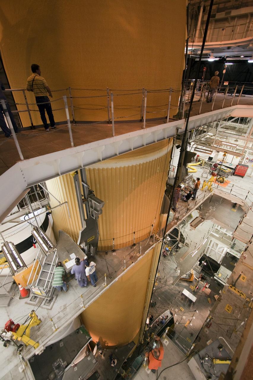 CAPE CANAVERAL, Fla. - In the Vehicle Assembly Building (VAB) at NASA's Kennedy Space Center in Florida, workers monitor the progress of external fuel tank, ET-138, for space shuttle Atlantis' STS-135 mission, as it is positioned between the twin solid rocket boosters on the mobile launcher platform in high bay-1. Shuttle Atlantis' move, or "rollover," from Orbiter Processing Facility-1 to the VAB is targeted for May 10. Once there it will be mated with the external tank and boosters. Atlantis and its crew of four will deliver the Raffaello multipurpose logistics module packed with supplies and spare parts to the International Space Station. STS-135 is targeted to launch June 28, and will be the last spaceflight for the Space Shuttle Program. Photo credit: NASA/Jack Pfaller