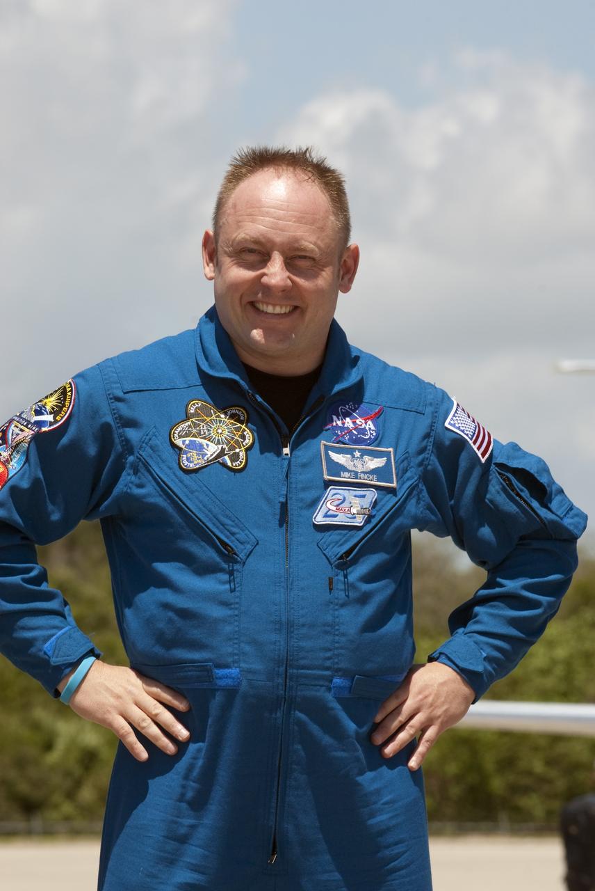 CAPE CANAVERAL, Fla. -- At the Shuttle Landing Facility at NASA's Kennedy Space Center in Florida, Mission Specialist Michael Fincke is photographed after his arrival. The STS-134 crew members landed at 12:52 p.m. EDT to get ready for space shuttle Endeavour's launch to the International Space Station scheduled for Friday, April 29 at 3:47 p.m. Endeavour and its crew will deliver the Express Logistics Carrier-3, Alpha Magnetic Spectrometer-2 (AMS), a high-pressure gas tank and additional spare parts for the Dextre robotic helper to the station. This will be the final spaceflight for Endeavour. For more information visit, www.nasa.gov/mission_pages/shuttle/shuttlemissions/sts134/index.html. Photo credit: NASA/Kim Shiflett