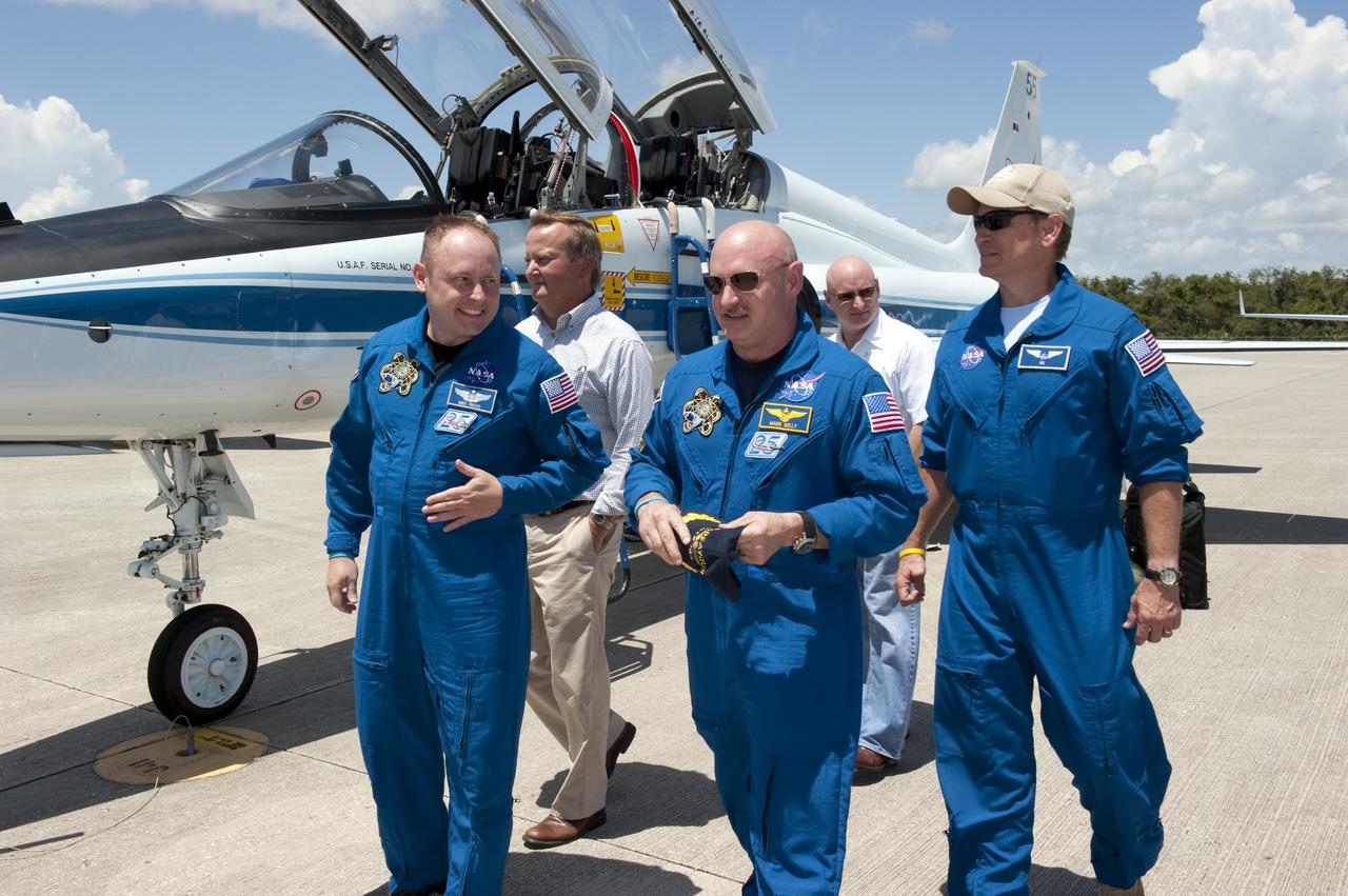 CAPE CANAVERAL, Fla. -- At NASA Kennedy Space Center's Shuttle Landing Facility in Florida, the STS-134 crew members arrive for final preparations for shuttle Endeavour's liftoff to the International Space Station. On the tarmac are from left (front row) Mission Specialist Michael Fincke and Commander Mark Kelly. Walking behind (from left) are Shuttle Launch Director Mike Leinbach, NASA astronaut Scott Kelly and Deputy Chief of Flight Crew Operations, Brian Kelly. Endeavour and its crew will deliver the Express Logistics Carrier-3, Alpha Magnetic Spectrometer-2 (AMS), a high-pressure gas tank and additional spare parts for the Dextre robotic helper to the station. This will be the final spaceflight for Endeavour. For more information visit, www.nasa.gov/mission_pages/shuttle/shuttlemissions/sts134/index.html. Photo credit: NASA/Kim Shiflett