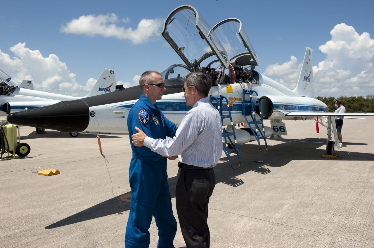 CAPE CANAVERAL, Fla. -- At NASA Kennedy Space Center's Shuttle Landing Facility in Florida, STS-134 Mission Specialist Andrew Feustel is greeted by Kennedy Center Director Bob Cabana after the crew's arrival for final preparations for shuttle Endeavour's liftoff to the International Space Station. Endeavour and its crew will deliver the Express Logistics Carrier-3, Alpha Magnetic Spectrometer-2 (AMS), a high-pressure gas tank and additional spare parts for the Dextre robotic helper to the station. This will be the final spaceflight for Endeavour. For more information visit, www.nasa.gov/mission_pages/shuttle/shuttlemissions/sts134/index.html. Photo credit: NASA/Kim Shiflett
