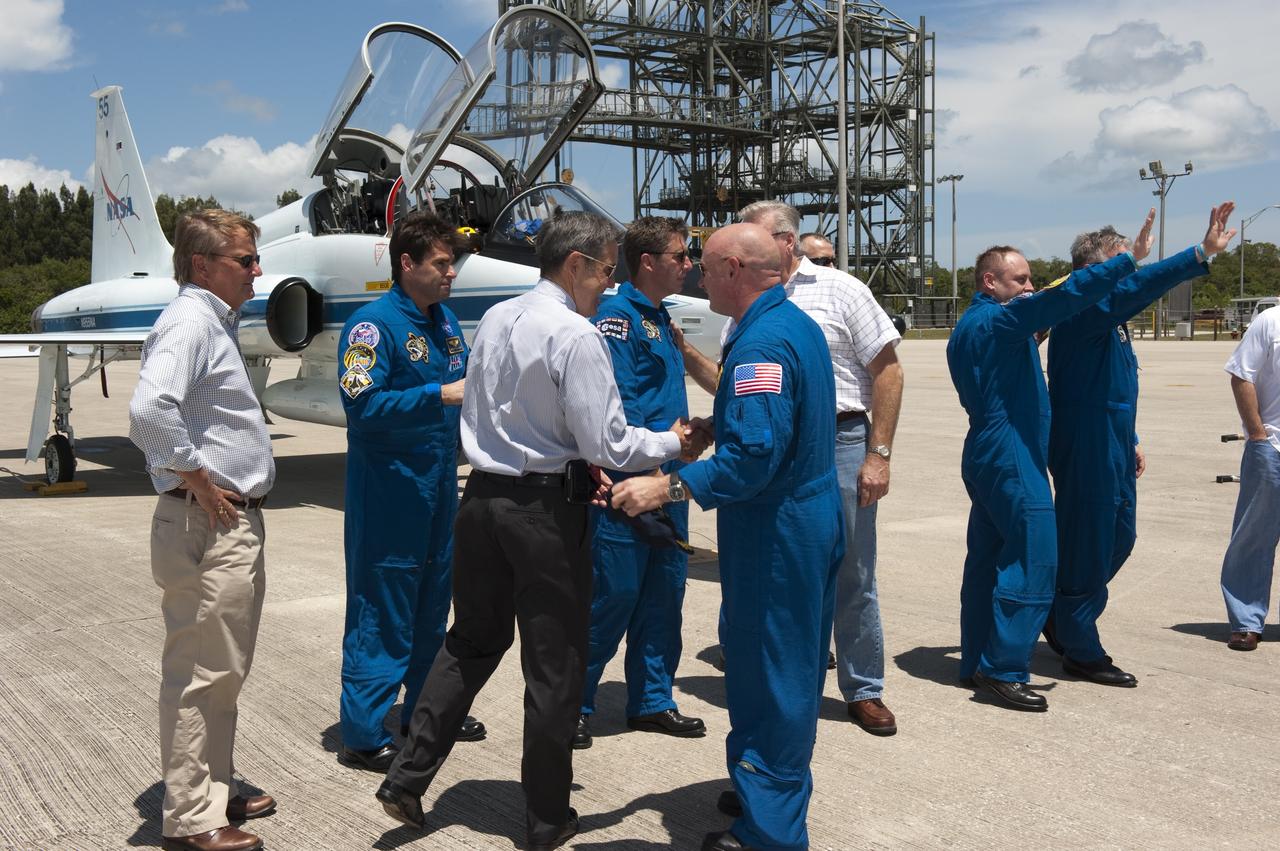 CAPE CANAVERAL, Fla. -- At NASA Kennedy Space Center's Shuttle Landing Facility in Florida, the STS-134 crew members are greeted by Kennedy Center Director Bob Cabana, Shuttle Launch Director Mike Leinbach and other NASA managers after the crew's arrival for final preparations for shuttle Endeavour's liftoff to the International Space Station. From center are Commander Mark Kelly, Bob Cabana, Mike Leinbach, Mission Specialists Greg Chamitoff, European Space Agency astronaut Roberto Vittori, Mission Specialists Andrew Feustel, Michael Fincke and Pilot Greg H. Johnson. Endeavour and its crew will deliver the Express Logistics Carrier-3, Alpha Magnetic Spectrometer-2 (AMS), a high-pressure gas tank and additional spare parts for the Dextre robotic helper to the station. This will be the final spaceflight for Endeavour. For more information visit, www.nasa.gov/mission_pages/shuttle/shuttlemissions/sts134/index.html. Photo credit: NASA/Kim Shiflett