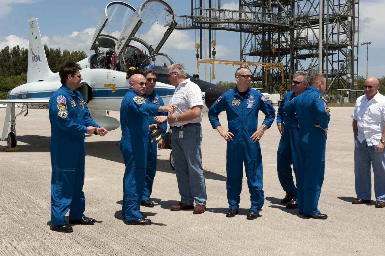 CAPE CANAVERAL, Fla. -- At NASA Kennedy Space Center's Shuttle Landing Facility in Florida, the STS-134 crew members are greeted by NASA managers and media. From left are Mission Specialist Greg Chamitoff, Commander Mark Kelly, European Space Agency astronaut Roberto Vittori, Mission Specialist Andrew Feustel, Pilot Greg H. Johnson, Mission Specialist Michael Fincke (turned away from camera) and NASA astronaut Scott Kelly. Endeavour and its crew will deliver the Express Logistics Carrier-3, Alpha Magnetic Spectrometer-2 (AMS), a high-pressure gas tank and additional spare parts for the Dextre robotic helper to the station. This will be the final spaceflight for Endeavour. For more information visit, www.nasa.gov/mission_pages/shuttle/shuttlemissions/sts134/index.html. Photo credit: NASA/Kim Shiflett