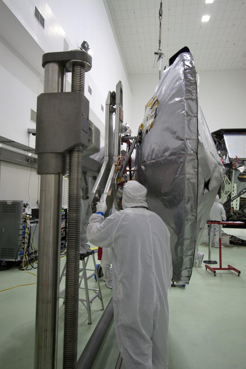 CAPE CANAVERAL, Fla. -- Technicians at Astrotech's payload processing facility in Titusville, Fla. attach an overhead crane to the high-gain antenna that will be installed to NASA's Juno spacecraft. Juno is scheduled to launch aboard an Atlas V rocket from Cape Canaveral, Fla. Aug. 5.The solar-powered spacecraft will orbit Jupiter's poles 33 times to find out more about the gas giant's origins, structure, atmosphere and magnetosphere and investigate the existence of a solid planetary core. For more information visit, www.nasa.gov/juno. Photo credit: NASA/Jack Pfaller