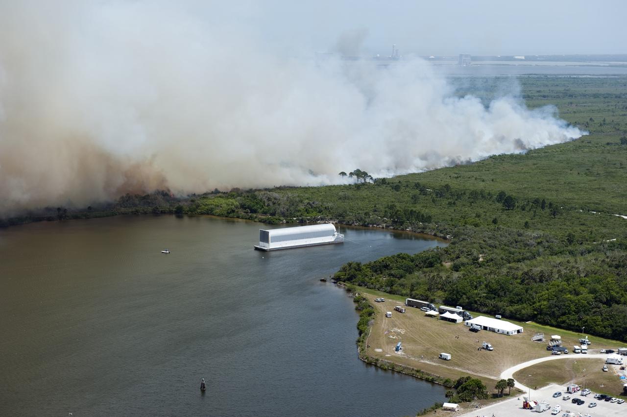 CAPE CANAVERAL, Fla. -- At NASA's Kennedy Space Center in Florida, smoke rises from a smoldering brush fire southeast of the Turn Basin. The fire was spotted near Kennedy’s Press Site approximately three miles away from Launch Pad 39A. The fires are being contained by firefighters from Kennedy Space Center and the U.S. Fish and Wildlife Service. No personnel are in danger and currently there is no to impact any operations related to space shuttle Endeavour’s launch countdown. Photo credit: NASA/Kim Shiflett