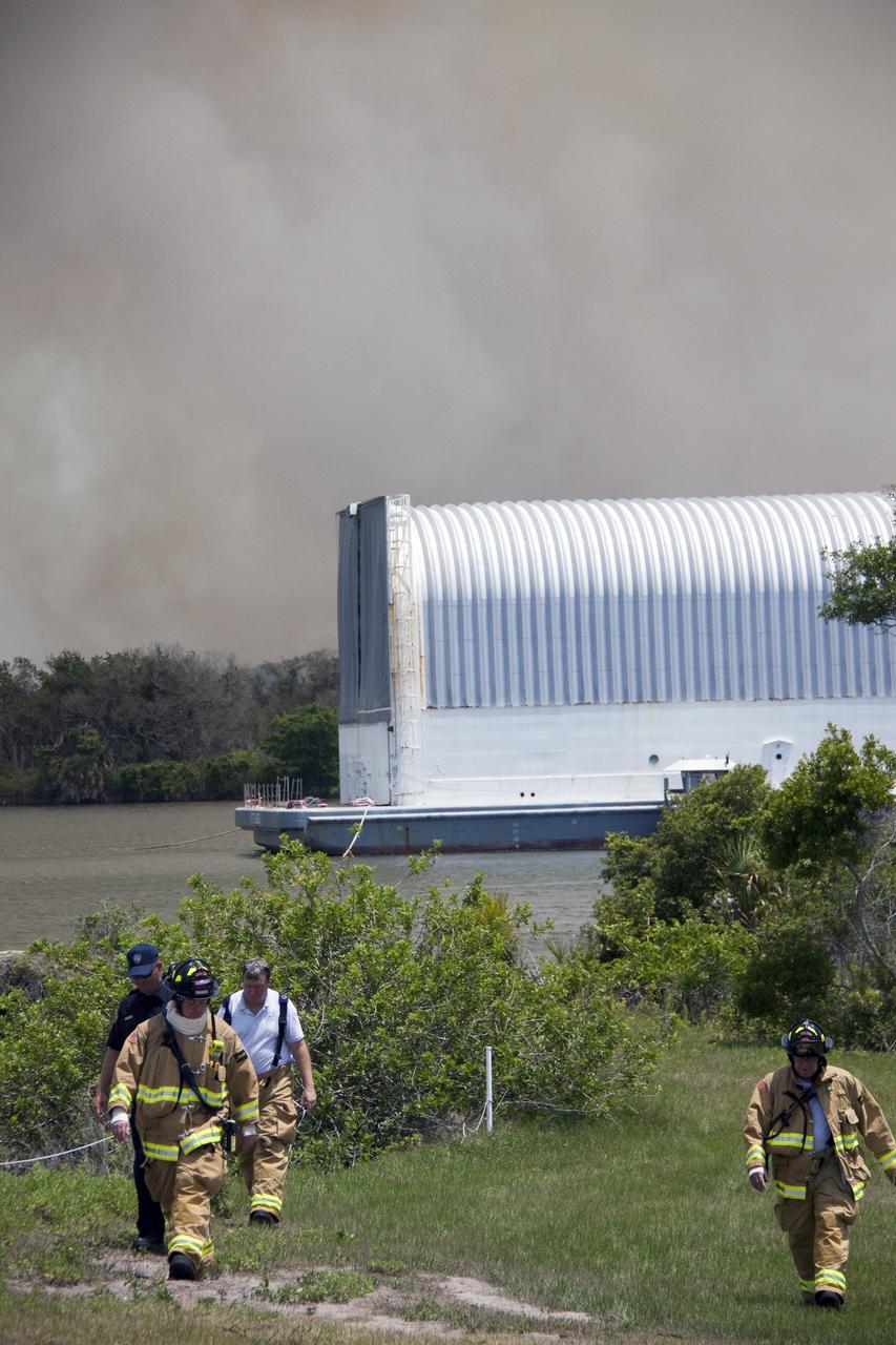 CAPE CANAVERAL, Fla. -- At NASA's Kennedy Space Center in Florida, smoke rises from a smoldering brush fire southeast of the Turn Basin. The fire was spotted near Kennedy’s Press Site approximately three miles away from Launch Pad 39A. The fires are being contained by firefighters from Kennedy Space Center and the U.S. Fish and Wildlife Service. No personnel are in danger and currently there is no to impact any operations related to space shuttle Endeavour’s launch countdown. Photo credit: NASA/Troy Cryder