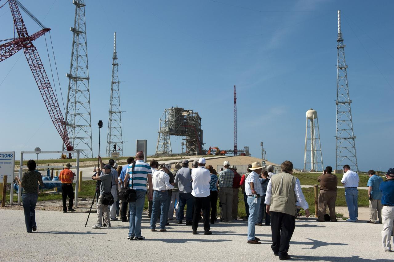 CAPE CANAVERAL, Fla. -- Media representatives participate in a Now and Future Tour at NASA's Kennedy Space Center in Florida. Here, they make a stop at the Launch Pad 39B, which is being restructured for future use. Its new design will feature a "clean pad" for rockets to come with their own launcher, making it more versatile for a number of vehicles. Other stops along the tour included Orbiter Processing Facility-2 (OPF-2) and the Shuttle Landing Facility (SLF). OPF-2 is where shuttle Discovery is being prepared for future public display at the Smithsonian's National Air and Space Museum Steven F. Udvar-Hazy Center in Chantilly, Va. The SLF's runway could be used for private companies and government agencies to host a diversity of launch systems, including orbital and suborbital flights. Photo credit: NASA/Kim Shiflett