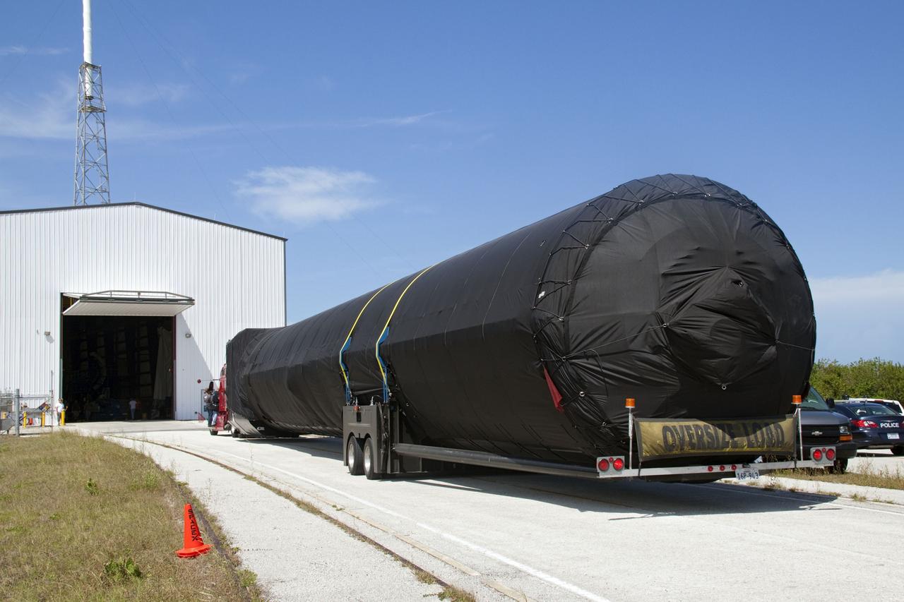 CAPE CANAVERAL, Fla. -- The first stage of the SpaceX COTS-2 Falcon 9 rocket is being moved into a SpaceX hangar at Pad 40 at Cape Canaveral Air Force Station in Florida.           Once assembled, it will be a two-stage fully integrated launch vehicle, consisting of a first stage powered by nine SpaceX-developed Merlin 1C engines, a second stage, an interstage, an unpressurized trunk and the Dragon spacecraft qualification unit. SpaceX was awarded procurement for three demonstration flights under the Commercial Orbital Transportation Services, or COTS, program managed by NASA's Johnson Space Center in Houston. A subsequent contract for Commercial Resupply Services, or CRS, was awarded in late 2008 to resupply the International Space Station. The SpaceX CRS contract provides for 12 missions to resupply the station from 2011 through 2015.  Photo credit: NASA/Jack Pfaller
