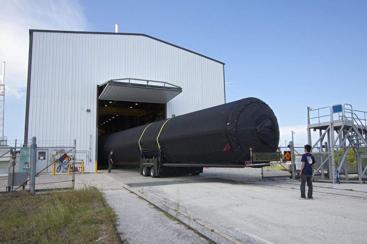 CAPE CANAVERAL, Fla. -- The first stage of the SpaceX COTS-2 Falcon 9 rocket is being moved into a SpaceX hangar at Pad 40 at Cape Canaveral Air Force Station in Florida.           Once assembled, it will be a two-stage fully integrated launch vehicle, consisting of a first stage powered by nine SpaceX-developed Merlin 1C engines, a second stage, an interstage, an unpressurized trunk and the Dragon spacecraft qualification unit. SpaceX was awarded procurement for three demonstration flights under the Commercial Orbital Transportation Services, or COTS, program managed by NASA's Johnson Space Center in Houston. A subsequent contract for Commercial Resupply Services, or CRS, was awarded in late 2008 to resupply the International Space Station. The SpaceX CRS contract provides for 12 missions to resupply the station from 2011 through 2015.  Photo credit: NASA/Jack Pfaller