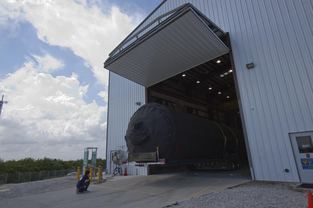 CAPE CANAVERAL, Fla. -- The first stage of the SpaceX COTS-2 Falcon 9 rocket is being moved into a SpaceX hangar at Pad 40 at Cape Canaveral Air Force Station in Florida.           Once assembled, it will be a two-stage fully integrated launch vehicle, consisting of a first stage powered by nine SpaceX-developed Merlin 1C engines, a second stage, an interstage, an unpressurized trunk and the Dragon spacecraft qualification unit. SpaceX was awarded procurement for three demonstration flights under the Commercial Orbital Transportation Services, or COTS, program managed by NASA's Johnson Space Center in Houston. A subsequent contract for Commercial Resupply Services, or CRS, was awarded in late 2008 to resupply the International Space Station. The SpaceX CRS contract provides for 12 missions to resupply the station from 2011 through 2015.  Photo credit: NASA/Jack Pfaller