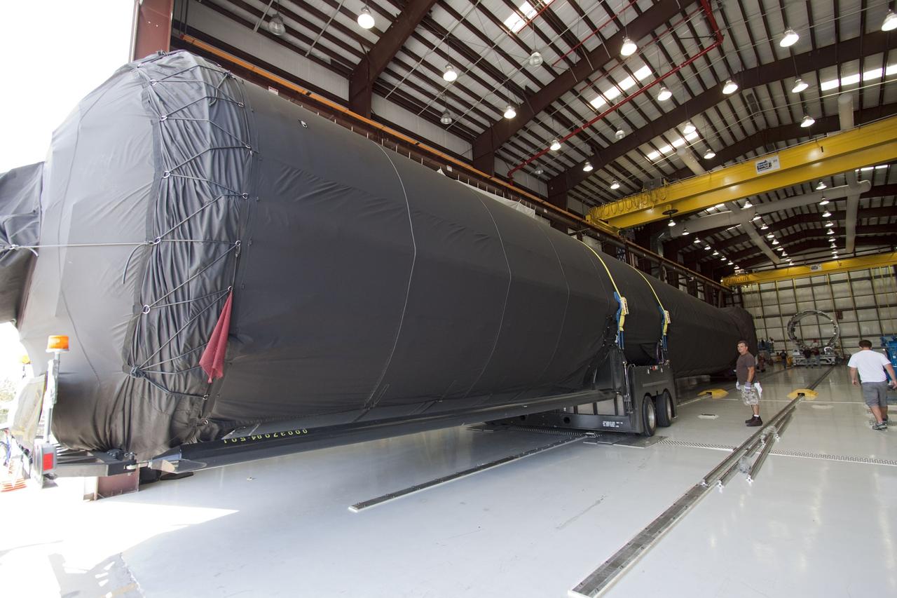 CAPE CANAVERAL, Fla. -- The first stage of the SpaceX COTS-2 Falcon 9 rocket has been moved to a SpaceX hangar at Pad 40 at Cape Canaveral Air Force Station in Florida.         Once assembled, it will be a two-stage fully integrated launch vehicle, consisting of a first stage powered by nine SpaceX-developed Merlin 1C engines, a second stage, an interstage, an unpressurized trunk and the Dragon spacecraft qualification unit. SpaceX was awarded procurement for three demonstration flights under the Commercial Orbital Transportation Services, or COTS, program managed by NASA's Johnson Space Center in Houston. A subsequent contract for Commercial Resupply Services, or CRS, was awarded in late 2008 to resupply the International Space Station. The SpaceX CRS contract provides for 12 missions to resupply the station from 2011 through 2015.  Photo credit: NASA/Jack Pfaller