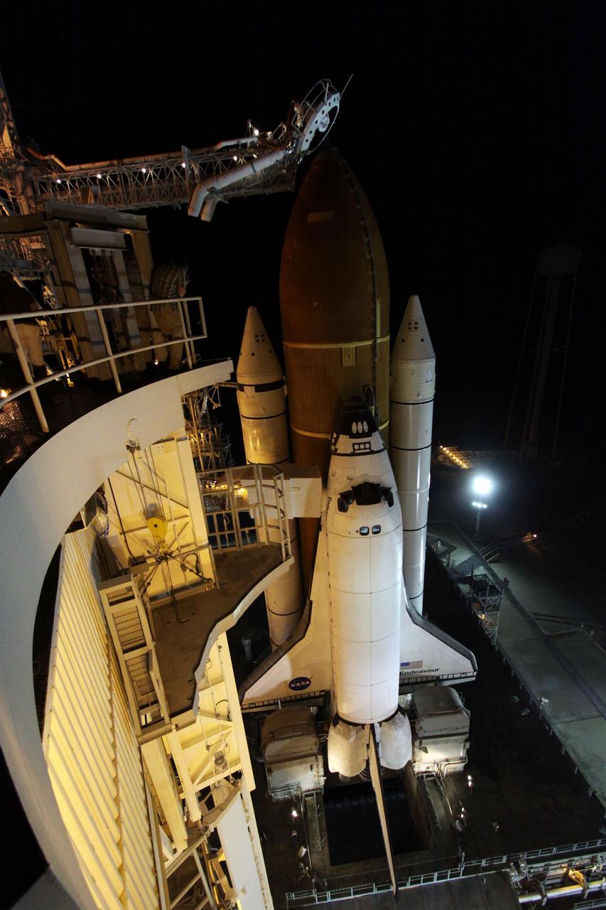 CAPE CANAVERAL, Fla. -- At NASA's Kennedy Space Center in Florida, space shuttle Endeavour is illuminated by bright xenon lights on Launch Pad 39A after the rotating service structure (RSS) was moved away. The structure provides weather protection and access to the shuttle while it awaits lift off on the pad. RSS "rollback," as it's called, began at 11:52 p.m. EDT on April 28. The move was scheduled to begin at 7 p.m., but storms over Kennedy delayed pad operations for a few hours. STS-134 will deliver the Express Logistics Carrier-3, Alpha Magnetic Spectrometer-2 (AMS), a high-pressure gas tank and additional spare parts for the Dextre robotic helper to the International Space Station. Endeavour was scheduled to launch at 3:47 p.m. on April 29, but that attempt was scrubbed for at least 72 hours while engineers assess an issue associated with the shuttle's Auxiliary Power Unit 1. STS-134 will be the final spaceflight for Endeavour. For more information visit, www.nasa.gov/mission_pages/shuttle/shuttlemissions/sts134/index.html. Photo credit: NASA/Ken Thornsley