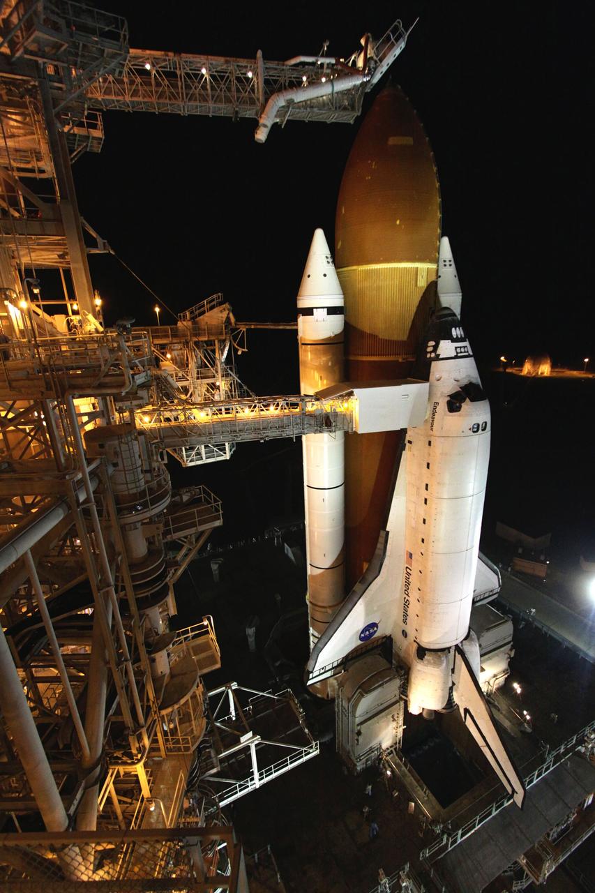 CAPE CANAVERAL, Fla. -- At NASA's Kennedy Space Center in Florida, space shuttle Endeavour is illuminated by bright xenon lights on Launch Pad 39A after the rotating service structure (RSS) was moved away. The structure provides weather protection and access to the shuttle while it awaits lift off on the pad. RSS "rollback," as it's called, began at 11:52 p.m. EDT on April 28. The move was scheduled to begin at 7 p.m., but storms over Kennedy delayed pad operations for a few hours. STS-134 will deliver the Express Logistics Carrier-3, Alpha Magnetic Spectrometer-2 (AMS), a high-pressure gas tank and additional spare parts for the Dextre robotic helper to the International Space Station. Endeavour was scheduled to launch at 3:47 p.m. on April 29, but that attempt was scrubbed for at least 72 hours while engineers assess an issue associated with the shuttle's Auxiliary Power Unit 1. STS-134 will be the final spaceflight for Endeavour. For more information visit, www.nasa.gov/mission_pages/shuttle/shuttlemissions/sts134/index.html. Photo credit: NASA/Ken Thornsley