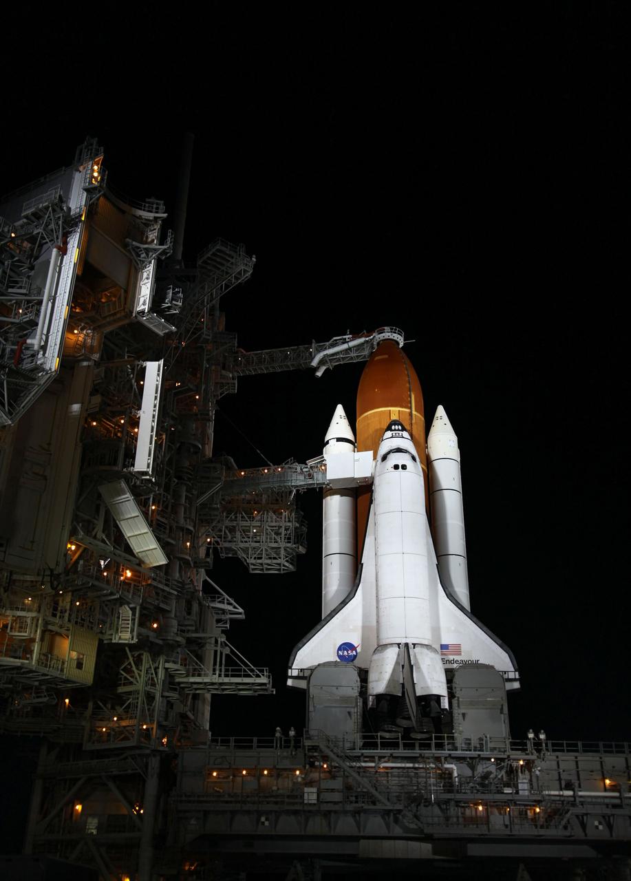 CAPE CANAVERAL, Fla. - At NASA's Kennedy Space Center in Florida, space shuttle Endeavour is illuminated by bright xenon lights on Launch Pad 39A after the rotating service structure (RSS) was moved away. The structure provides weather protection and access to the shuttle while it awaits lift off on the pad. RSS "rollback," as it's called, began at 11:52 p.m. EDT on April 28. The move was scheduled to begin at 7 p.m., but storms over Kennedy delayed pad operations for a few hours. STS-134 will deliver the Express Logistics Carrier-3, Alpha Magnetic Spectrometer-2 (AMS), a high-pressure gas tank and additional spare parts for the Dextre robotic helper to the International Space Station. Endeavour was scheduled to launch at 3:47 p.m. on April 29, but that attempt was scrubbed for at least 72 hours while engineers assess an issue associated with the shuttle's Auxiliary Power Unit 1. STS-134 will be the final spaceflight for Endeavour. For more information visit, www.nasa.gov/mission_pages/shuttle/shuttlemissions/sts134/index.html. Photo credit: NASA/Ken Thornsley
