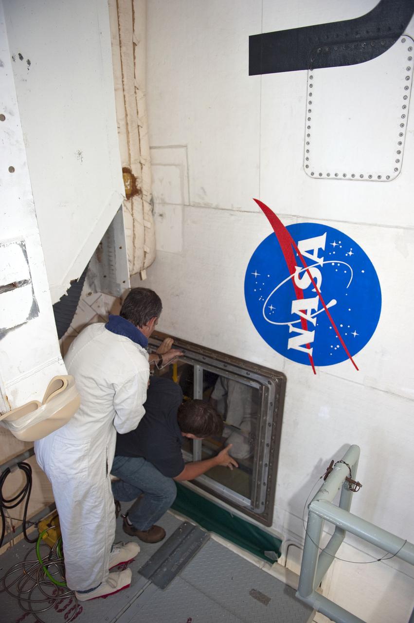 CAPE CANAVERAL, Fla. -- At NASA Kennedy Space Center's Launch Pad 39A, workers gain entrance to space shuttle Endeavour's aft section as teams prepare to remove and replace the aft load control assembly-2 (ALCA-2). Located in the orbiter's aft avionics bay 5, the assembly is believed to have caused heaters on a fuel line for Endeavour's auxiliary power unit-1 (APU-1) to fail April 29 during the first launch attempt for the STS-134 mission. STS-134 will deliver the Express Logistics Carrier-3, Alpha Magnetic Spectrometer-2 (AMS), a high-pressure gas tank and additional spare parts for the Dextre robotic helper to the International Space Station. The mission also will be the final spaceflight for Endeavour. For more information, visit www.nasa.gov/mission_pages/shuttle/shuttlemissions/sts134/index.html. Photo credit: NASA/Kim Shiflett
