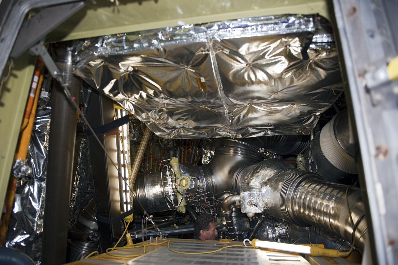 CAPE CANAVERAL, Fla. -- Barely visible inside space shuttle Endeavour's aft section, a technician at NASA Kennedy Space Center's Launch Pad 39A helps prepare for the upcoming removal and replacement of the aft load control assembly-2 (ALCA-2). Located in the orbiter's aft avionics bay 5, the assembly is believed to have caused heaters on a fuel line for Endeavour's auxiliary power unit-1 (APU-1) to fail April 29 during the first launch attempt for the STS-134 mission. STS-134 will deliver the Express Logistics Carrier-3, Alpha Magnetic Spectrometer-2 (AMS), a high-pressure gas tank and additional spare parts for the Dextre robotic helper to the International Space Station. The mission also will be the final spaceflight for Endeavour. For more information, visit www.nasa.gov/mission_pages/shuttle/shuttlemissions/sts134/index.html. Photo credit: NASA/Kim Shiflett