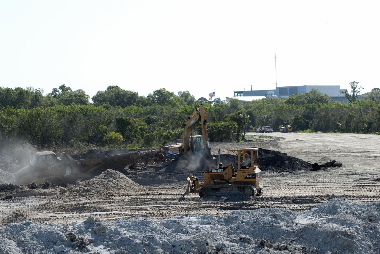 CAPE CANAVERAL, Fla. -- Crews continue to clear land and prepare for the construction of a new road at the Exploration Park site near the Space Life Sciences Laboratory (SLSL) at NASA's Kennedy Space Center in Florida. The first phase will encompass 60 acres just outside Kennedy’s security gates. Nine buildings will provide 350,000-square feet of work space, including educational, office, research and lab, and high-bay facilities. Each building is expected to be certified in the U.S. Green Building Council’s Leadership in Environmental and Energy Design (LEED). Exploration Park is designed to be a strategically located complex, adjacent to the SLSL, for servicing diverse tenants and uses that will engage in activities to support space-related activities of NASA, other government agencies and the U.S. commercial space industry. It also is expected to bring new aerospace work to the Space Coast. The SLSL will be the anchor facility for the park, which is expected to open its first new facility in early 2012. Photo credit: NASA/Jim Grossmann