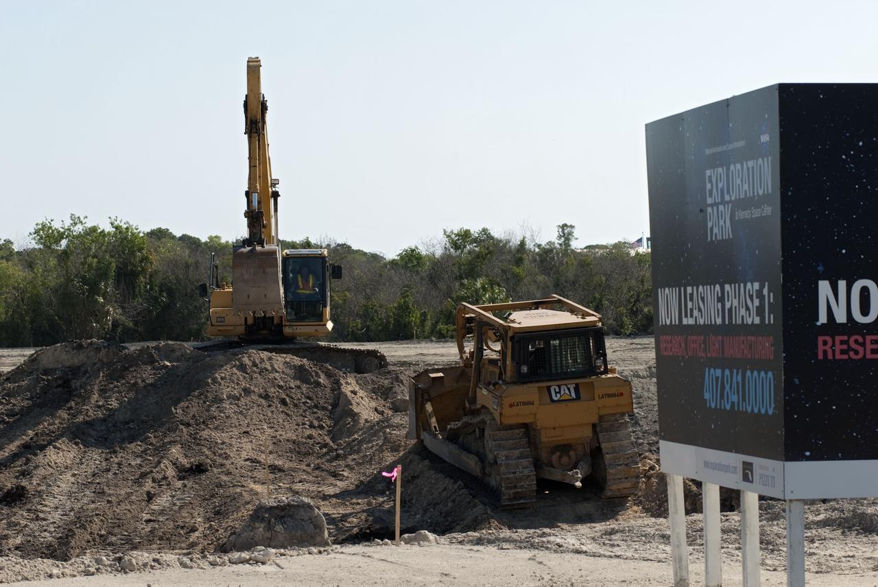 CAPE CANAVERAL, Fla. -- Crews continue to clear land and prepare for the construction of a new road at the Exploration Park site near the Space Life Sciences Laboratory (SLSL) at NASA's Kennedy Space Center in Florida. The first phase will encompass 60 acres just outside Kennedy’s security gates. Nine buildings will provide 350,000-square feet of work space, including educational, office, research and lab, and high-bay facilities. Each building is expected to be certified in the U.S. Green Building Council’s Leadership in Environmental and Energy Design (LEED). Exploration Park is designed to be a strategically located complex, adjacent to the SLSL, for servicing diverse tenants and uses that will engage in activities to support space-related activities of NASA, other government agencies and the U.S. commercial space industry. It also is expected to bring new aerospace work to the Space Coast. The SLSL will be the anchor facility for the park, which is expected to open its first new facility in early 2012. Photo credit: NASA/Jim Grossmann