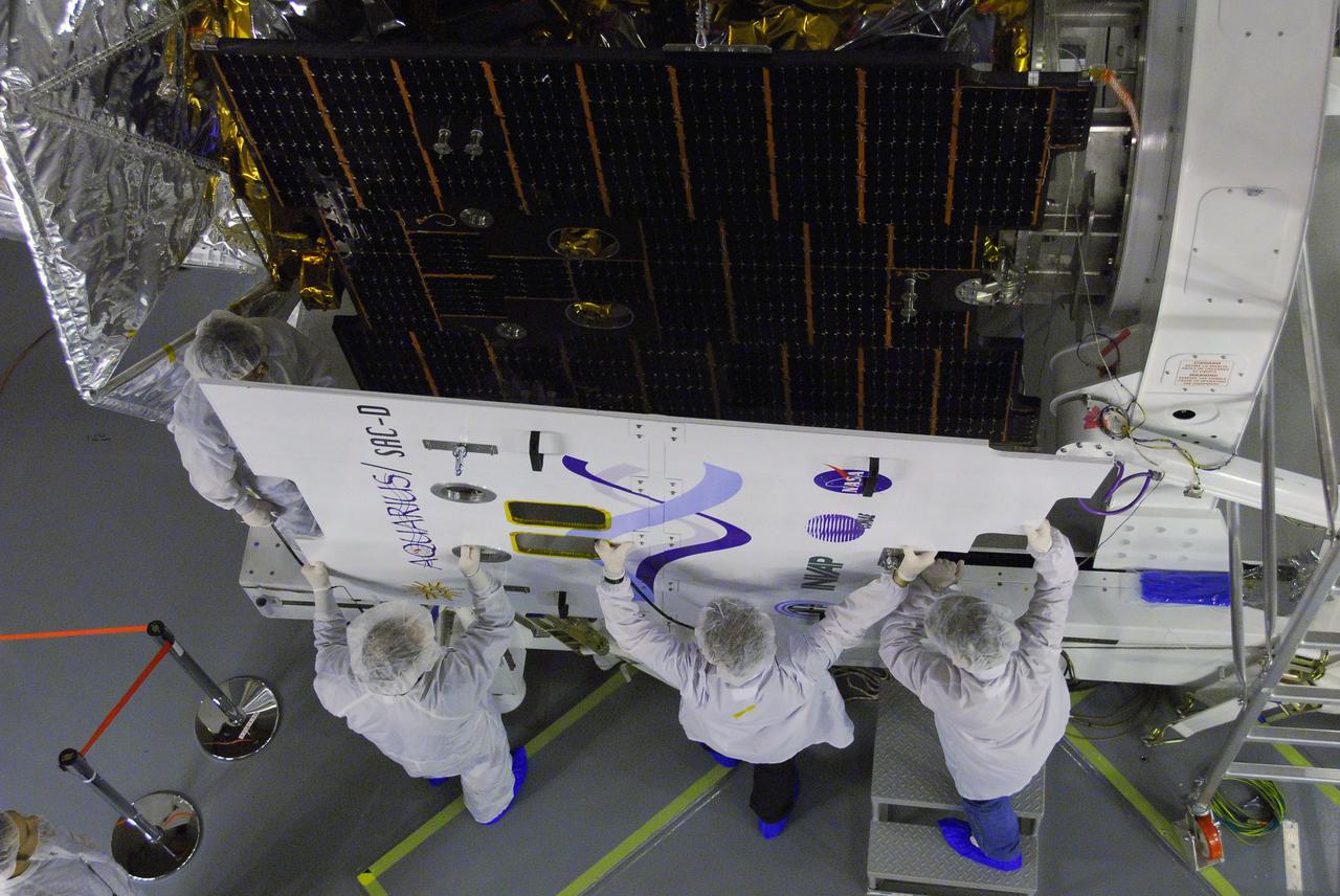 VANDENBERG AIR FORCE BASE, Calif. -- In Space Systems International's Payload Processing Facility at Vandenberg Air Force Base in California, technicians remove a protective cover from the solar array after integration to the Aquarius/SAC-D spacecraft.   Following final tests, the spacecraft will be integrated to a United Launch Alliance Delta II rocket in preparation for the targeted June launch. Aquarius, the NASA-built primary instrument on the SAC-D spacecraft, will provide new insights into how variations in ocean surface salinity relate to fundamental climate processes on its three-year mission. Photo credit: NASA/VAFB