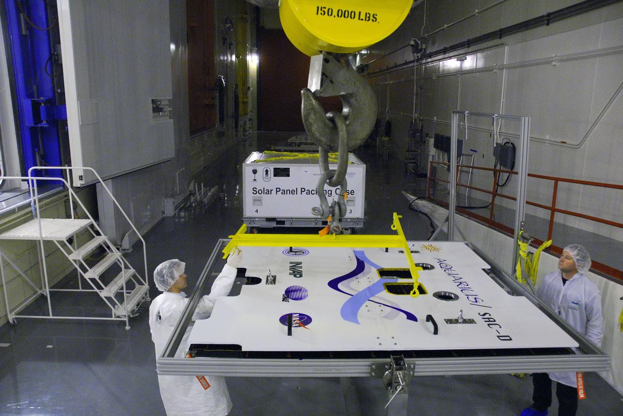 VANDENBERG AIR FORCE BASE, Calif. --In Space Systems International's Payload Processing Facility at Vandenberg Air Force Base in California, technicians attach an overhead crane to the second solar array that will be integrated to the Aquarius/SAC-D spacecraft.  Following final tests, the spacecraft will be integrated to a United Launch Alliance Delta II rocket in preparation for the targeted June launch. Aquarius, the NASA-built primary instrument on the SAC-D spacecraft, will provide new insights into how variations in ocean surface salinity relate to fundamental climate processes on its three-year mission. Photo credit: NASA/VAFB
