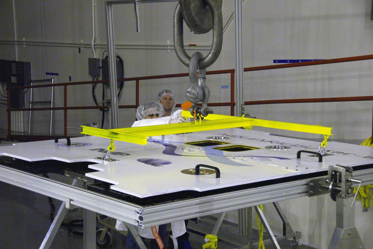 VANDENBERG AIR FORCE BASE, Calif. --In Space Systems International's Payload Processing Facility at Vandenberg Air Force Base in California, technicians attach an overhead crane to the second solar array that will be integrated to the Aquarius/SAC-D spacecraft.  Following final tests, the spacecraft will be integrated to a United Launch Alliance Delta II rocket in preparation for the targeted June launch. Aquarius, the NASA-built primary instrument on the SAC-D spacecraft, will provide new insights into how variations in ocean surface salinity relate to fundamental climate processes on its three-year mission. Photo credit: NASA/VAFB