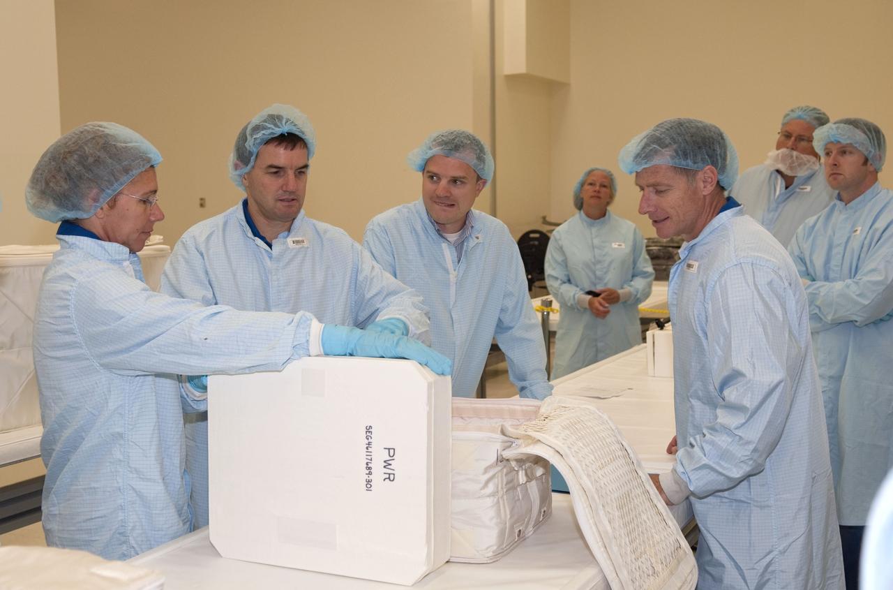 CAPE CANAVERAL, Fla. -- Space shuttle Atlantis' STS-135 crew participates in a crew equipment interface test, or CEIT, in the Space Station Processing Facility at NASA's Kennedy Space Center in Florida. The purpose of CEIT is for flight crew members to become familiar with the hardware and tools they will work with in space. Working behind the table are Mission Specialists Sandy Magnus, left, and Rex Walheim. Commander Chris Ferguson observes from the front of the table, as do technicians. STS-135 will carry the Raffaello multi-purpose logistics module packed with supplies, logistics and spare parts to the International Space Station. STS-135 also will return a failed ammonia pump module on the Lightweight Multi-Purpose Experiment Support Structure Carrier, or LMC, to help NASA better understand the failure mechanism and improve pump designs for future systems.            STS-135, targeted to launch June 28, will be the 33rd flight of Atlantis, the 37th shuttle mission to the space station, and the 135th and final mission of NASA's Space Shuttle Program. For more information visit, www.nasa.gov/mission_pages/shuttle/shuttlemissions/sts135/index.html. Photo credit: NASA/Jim Grossmann