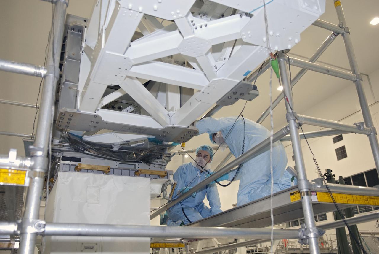 CAPE CANAVERAL, Fla. -- Space shuttle Atlantis' STS-135 crew participates in a crew equipment interface test, or CEIT, in the Space Station Processing Facility at NASA's Kennedy Space Center in Florida. The purpose of CEIT is for flight crew members to become familiar with the hardware and tools they will work with in space. Here, a technician shows Mission Specialist Rex Walheim the Lightweight Multi-Purpose Experiment Support Structure Carrier, or LMC, which will be used to return a failed ammonia pump module from the International Space Station. Crews on Earth will examine the failure mechanism to help NASA improve pump designs for future systems. STS-135 also will carry the Raffaello multi-purpose logistics module packed with supplies, logistics and spare parts.    STS-135, targeted to launch June 28, will be the 33rd flight of Atlantis, the 37th shuttle mission to the space station, and the 135th and final mission of NASA's Space Shuttle Program. For more information visit, www.nasa.gov/mission_pages/shuttle/shuttlemissions/sts135/index.html. Photo credit: NASA/Jim Grossmann