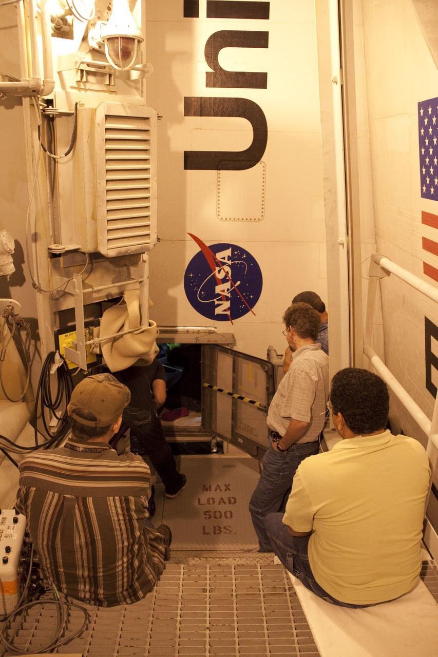 CAPE CANAVERAL, Fla. -- At NASA Kennedy Space Center's Launch Pad 39A, technicians work to remove the Load Control Assembly-2 (LCA-2) from inside space shuttle Endeavour's aft section. Located in the orbiter's aft avionics bay 5, the LCA-2 assembly, which feeds power to the fuel line heaters, is believed to have caused the heaters for Endeavour's auxiliary power unit-1 (APU-1) to fail April 29 during the first launch attempt for the STS-134 mission. The assembly will be replaced and systems will be retested before the launch is rescheduled.            STS-134 will deliver the Express Logistics Carrier-3, Alpha Magnetic Spectrometer-2 (AMS), a high-pressure gas tank and additional spare parts for the Dextre robotic helper to the International Space Station. The mission also will be the final spaceflight for Endeavour. For more information, visit www.nasa.gov/mission_pages/shuttle/shuttlemissions/sts134/index.html. Photo credit: NASA/Troy Cryder