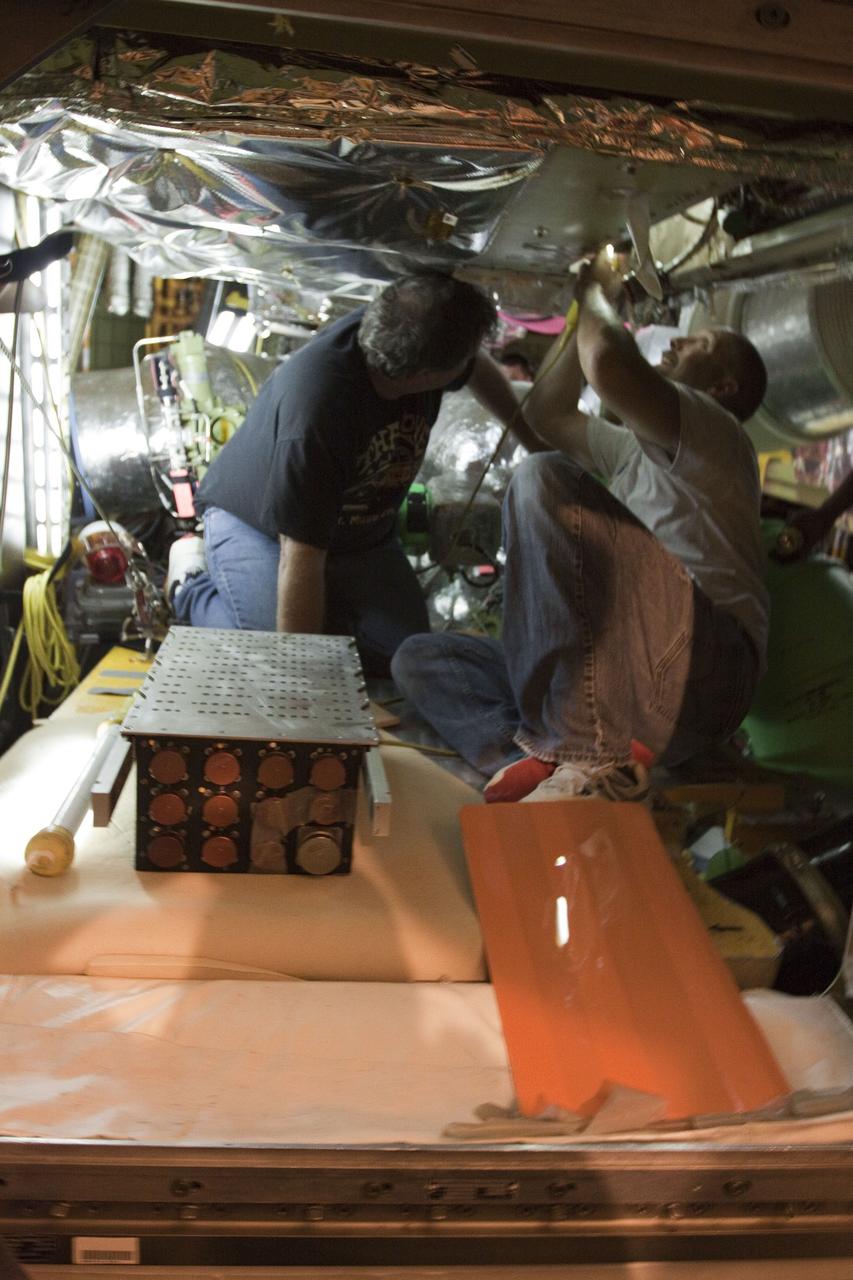 CAPE CANAVERAL, Fla. -- At NASA Kennedy Space Center's Launch Pad 39A, the Load Control Assembly-2 (LCA-2) is removed from inside space shuttle Endeavour's aft section. Located in the orbiter's aft avionics bay 5, the LCA-2 assembly, which feeds power to the fuel line heaters, is believed to have caused the heaters for Endeavour's auxiliary power unit-1 (APU-1) to fail April 29 during the first launch attempt for the STS-134 mission. The assembly will be replaced and systems will be retested before the launch is rescheduled.        STS-134 will deliver the Express Logistics Carrier-3, Alpha Magnetic Spectrometer-2 (AMS), a high-pressure gas tank and additional spare parts for the Dextre robotic helper to the International Space Station. The mission also will be the final spaceflight for Endeavour. For more information, visit www.nasa.gov/mission_pages/shuttle/shuttlemissions/sts134/index.html. Photo credit: NASA/Troy Cryder