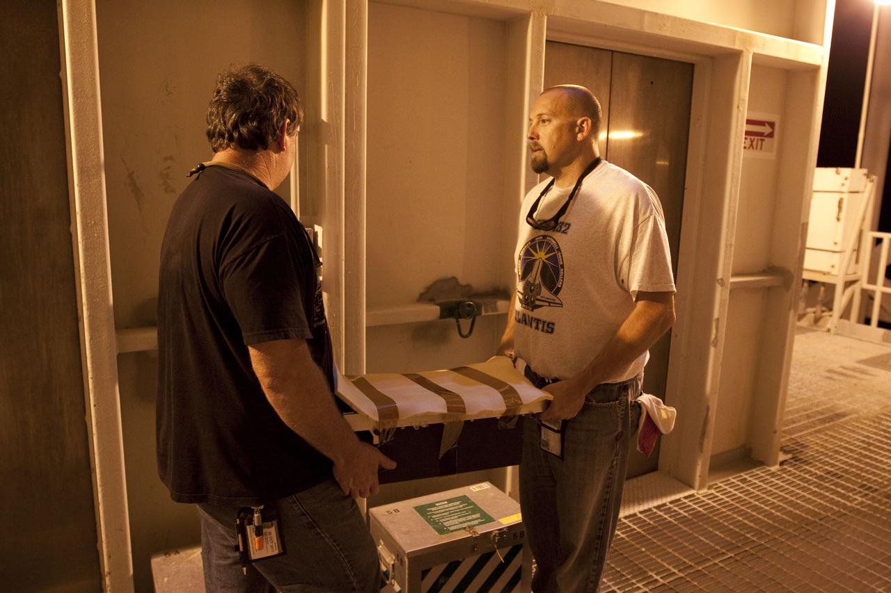 CAPE CANAVERAL, Fla. -- At NASA Kennedy Space Center's Launch Pad 39A, technicians carry away the Load Control Assembly-2 (LCA-2) after it was removed from inside space shuttle Endeavour's aft section. Located in the orbiter's aft avionics bay 5, the LCA-2 assembly, which feeds power to the fuel line heaters, is believed to have caused the heaters for Endeavour's auxiliary power unit-1 (APU-1) to fail April 29 during the first launch attempt for the STS-134 mission. The assembly will be replaced and systems will be retested before the launch is rescheduled.        STS-134 will deliver the Express Logistics Carrier-3, Alpha Magnetic Spectrometer-2 (AMS), a high-pressure gas tank and additional spare parts for the Dextre robotic helper to the International Space Station. The mission also will be the final spaceflight for Endeavour. For more information, visit www.nasa.gov/mission_pages/shuttle/shuttlemissions/sts134/index.html. Photo credit: NASA/Troy Cryder