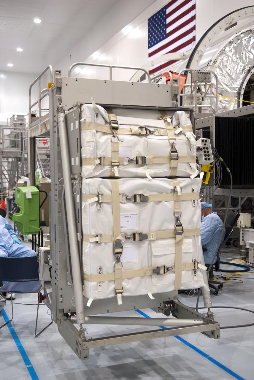 CAPE CANAVERAL, Fla. -- In the Space Station Processing Facility at NASA's Kennedy Space Center in Florida, cargo bags are secured on a resupply stowage platform and await installation inside the Raffaello multi-purpose logistics module, in the background at right, for space shuttle Atlantis' flight to the International Space Station. Atlantis and its payload are being prepared for the STS-135 mission, which will deliver Raffaello packed with supplies and spare parts to the station. STS-135, targeted to launch June 28, will be the 33rd flight of Atlantis, the 37th shuttle mission to the space station, and the 135th and final mission of NASA's Space Shuttle Program. For more information, visit www.nasa.gov/mission_pages/shuttle/shuttlemissions/sts135/index.html. Photo credit: NASA/Jim Grossmann